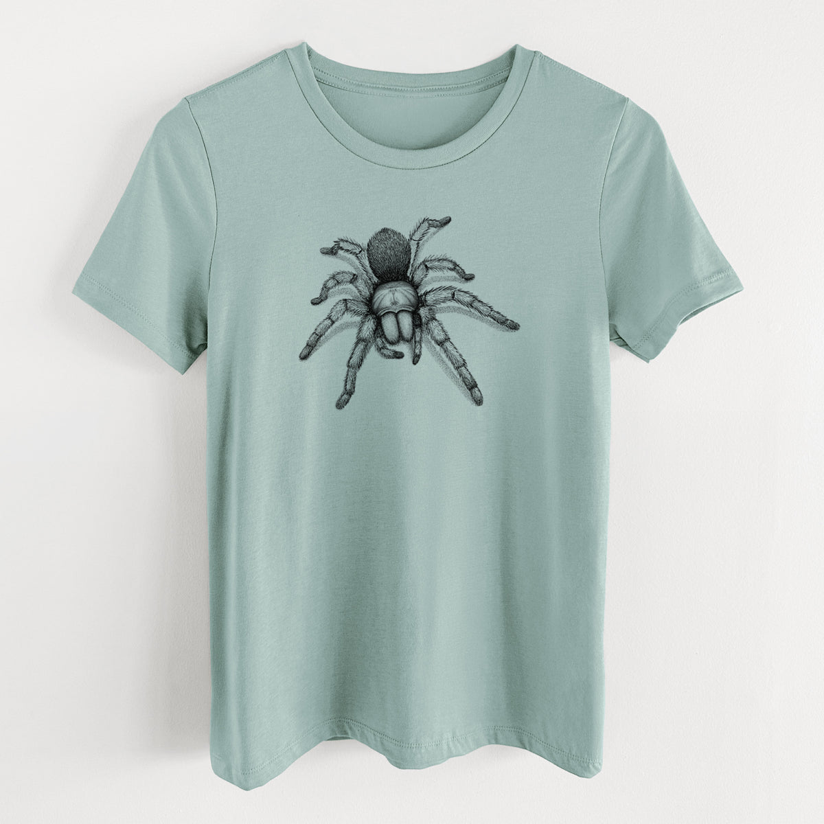 Dusty blue women's relaxed fit cotton t-shirt laid flat, printed with a detailed black ink illustration of a desert blonde tarantula.