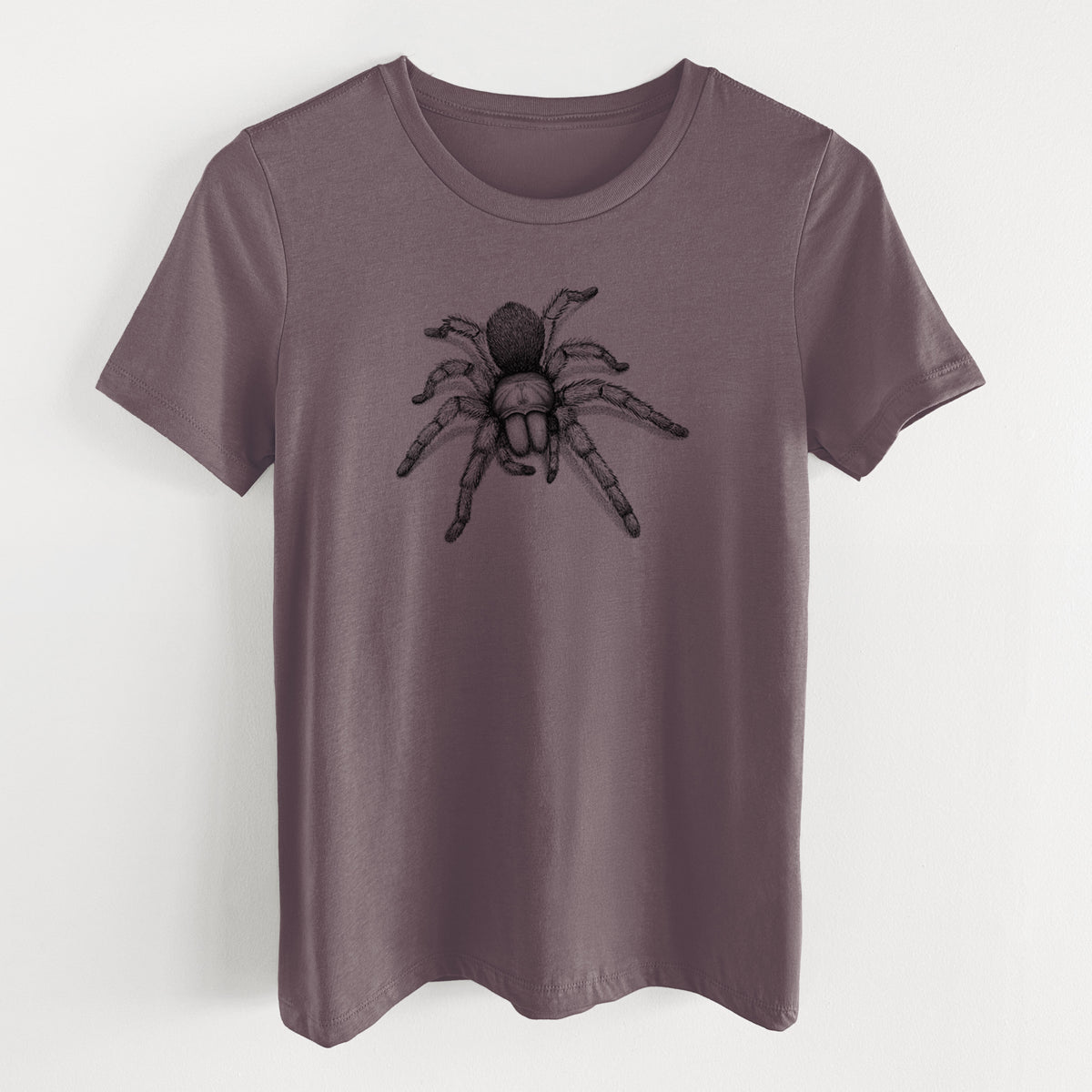 Purple storm women's relaxed fit cotton t-shirt laid flat, printed with a detailed black ink illustration of a desert blonde tarantula.