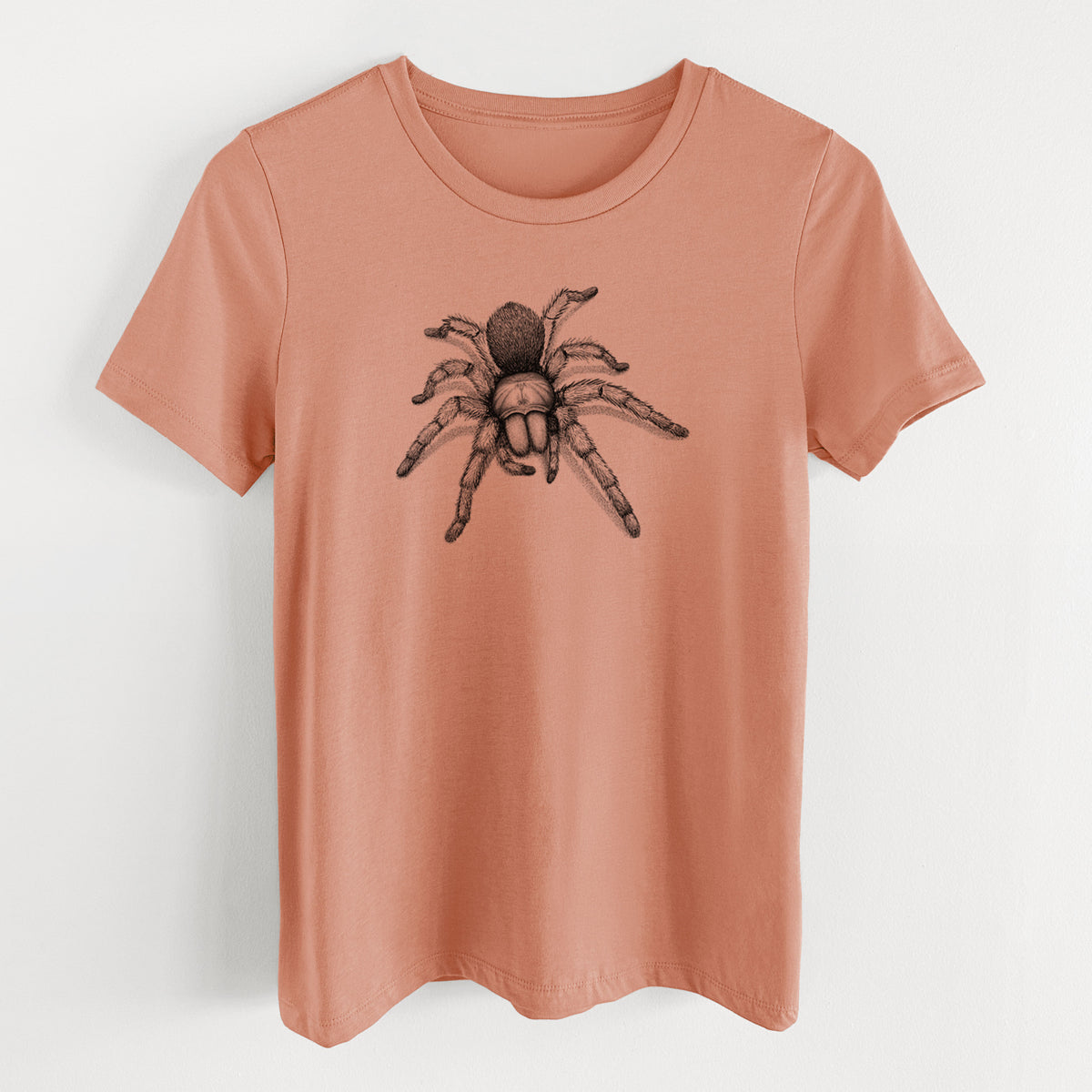 Terracotta orange women's relaxed fit cotton t-shirt laid flat, printed with a detailed black ink illustration of a desert blonde tarantula.