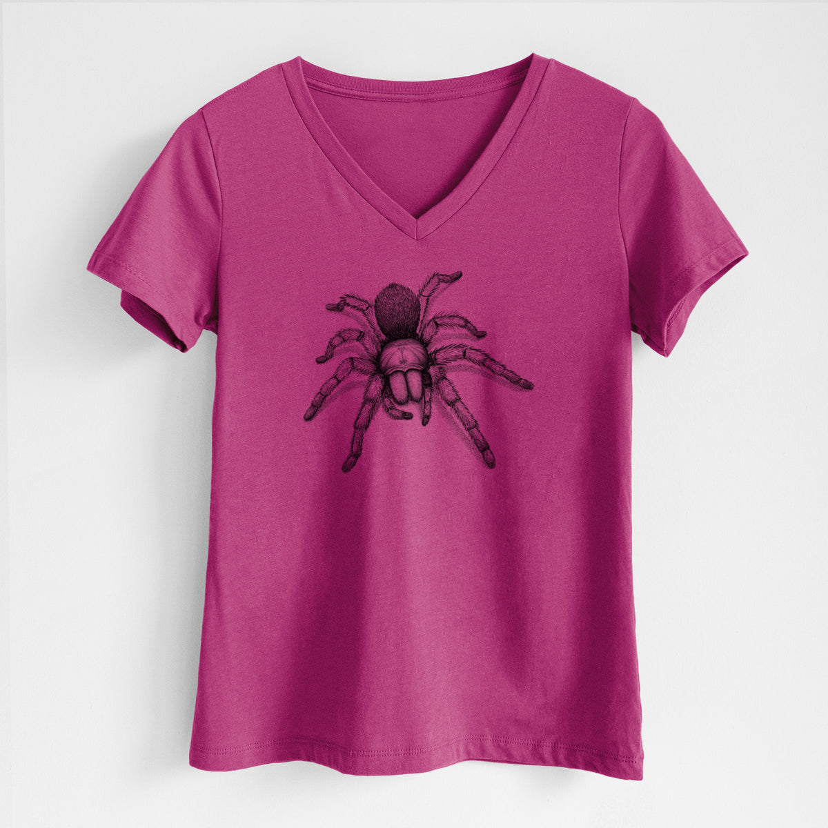 Berry pink women's relaxed fit cotton V-neck t-shirt laid flat, printed with a detailed black ink illustration of a desert blonde tarantula.