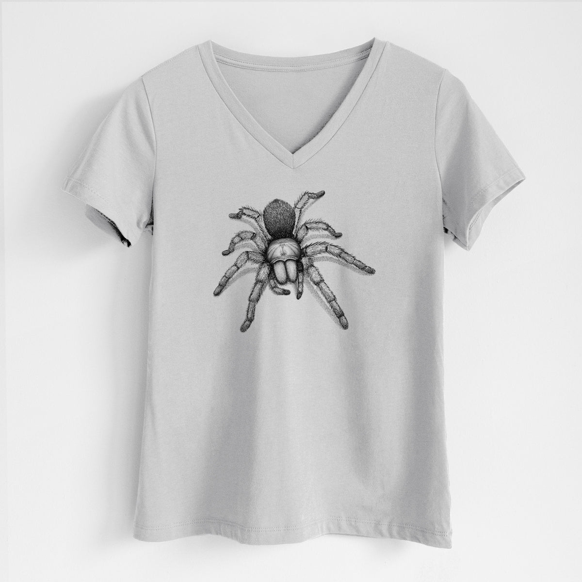 Lunar grey women's relaxed fit cotton V-neck t-shirt laid flat, printed with a detailed black ink illustration of a desert blonde tarantula.