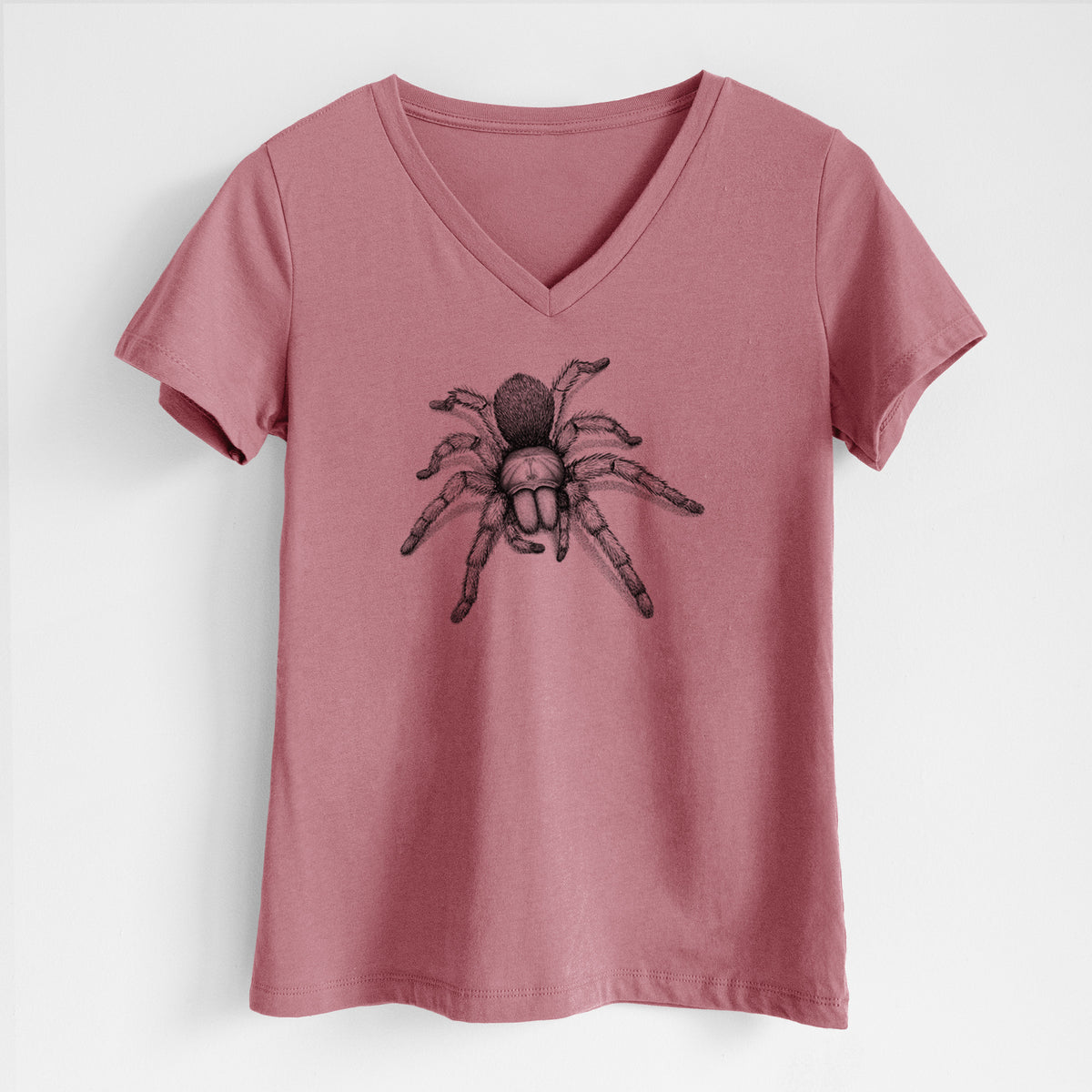 Mauve pink women's relaxed fit cotton V-neck t-shirt laid flat, printed with a detailed black ink illustration of a desert blonde tarantula.
