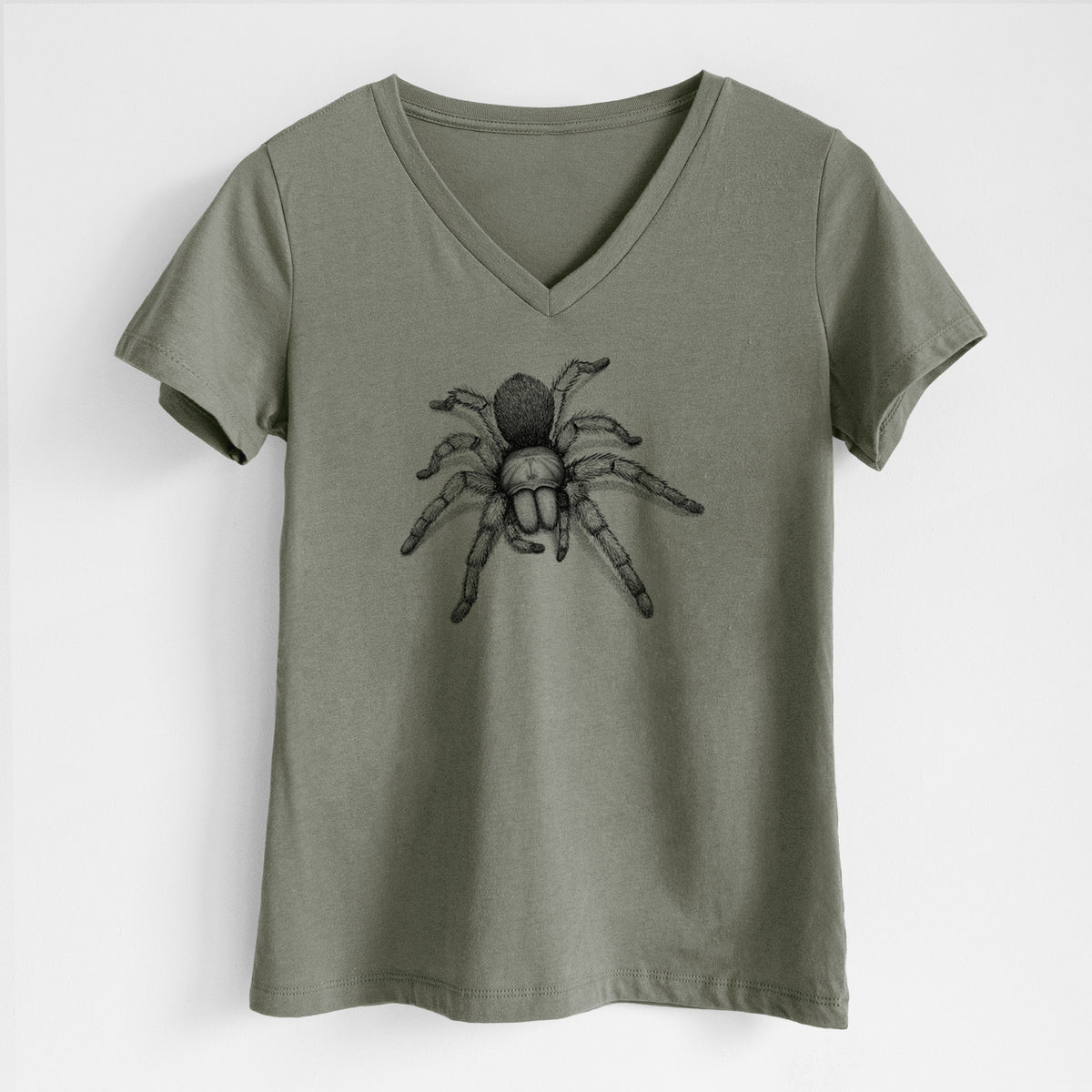 Military green women's relaxed fit cotton V-neck t-shirt laid flat, printed with a detailed black ink illustration of a desert blonde tarantula.