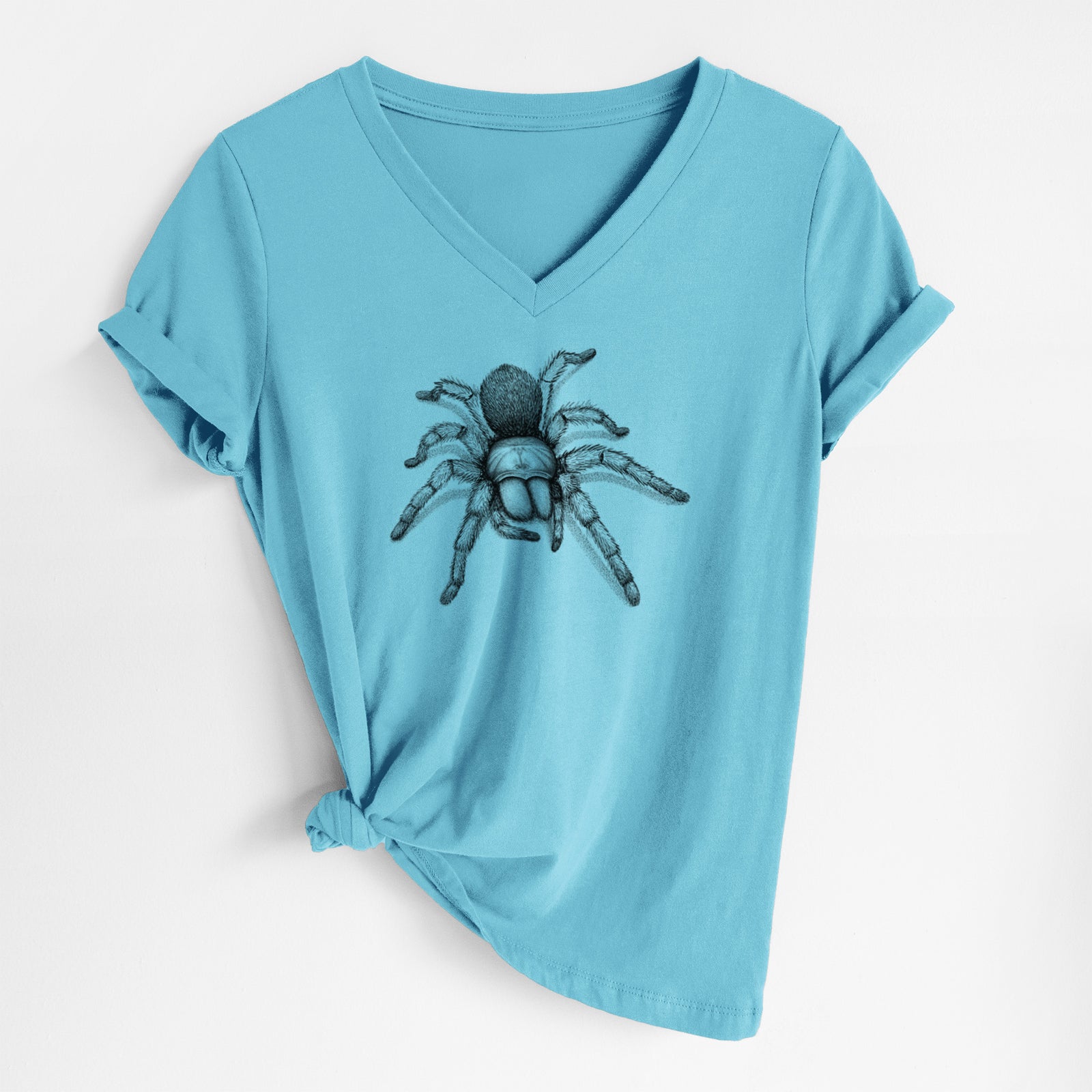 Turquoise women's relaxed fit cotton V-neck t-shirt laid flat, printed with a detailed black ink illustration of a desert blonde tarantula.