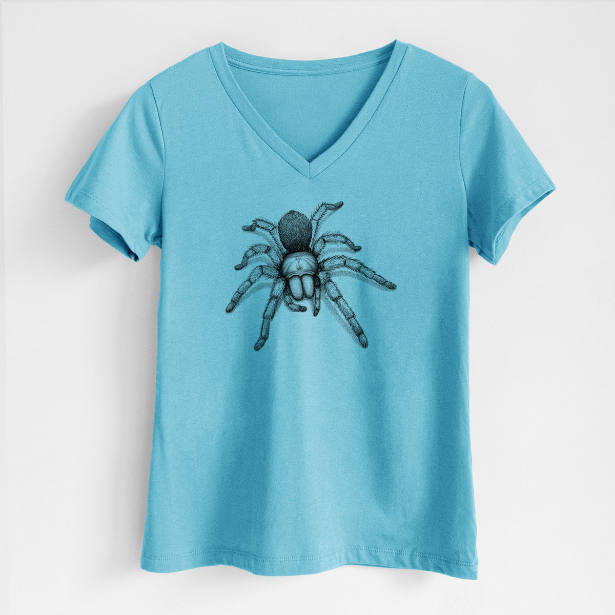 Turquoise women's relaxed fit cotton V-neck t-shirt laid flat, printed with a detailed black ink illustration of a desert blonde tarantula.