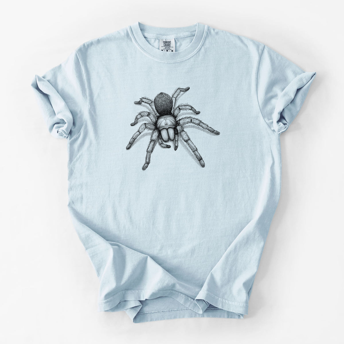 Chambray blue Comfort Colors t-shirt laid flat, printed with a detailed black ink illustration of a desert blonde tarantula.