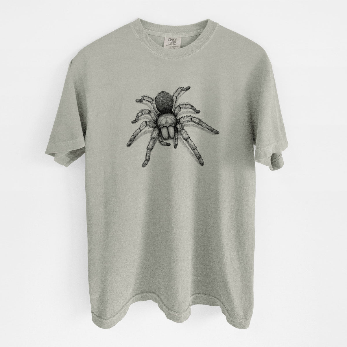 Sandstone beige Comfort Colors t-shirt laid flat, printed with a detailed black ink illustration of a desert blonde tarantula.