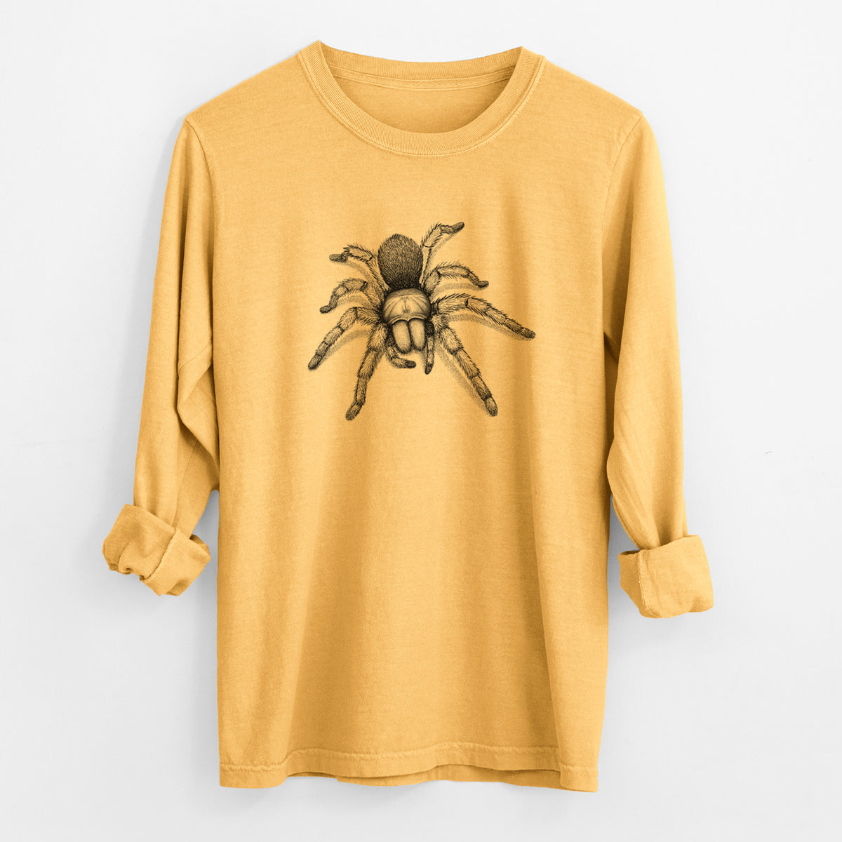 Golden wheat yellow Comfort Colors long sleeve shirt laid flat with the cuffs rolled, printed with a detailed black ink illustration of a desert blonde tarantula.