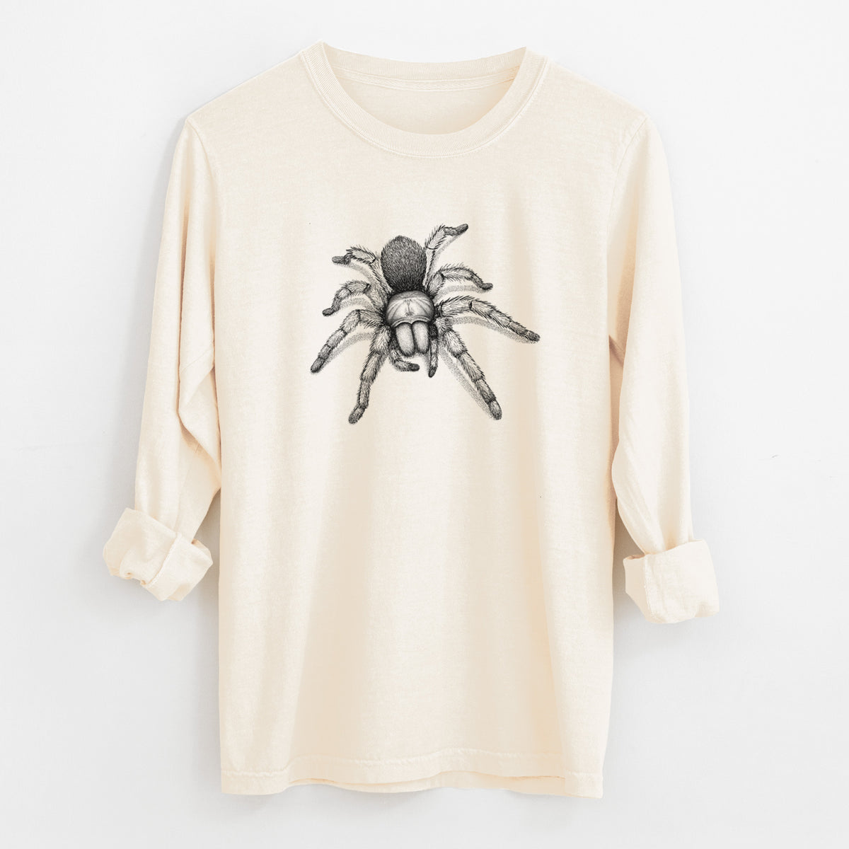 Ivory Comfort Colors long sleeve shirt laid flat with the cuffs rolled, printed with a detailed black ink illustration of a desert blonde tarantula.