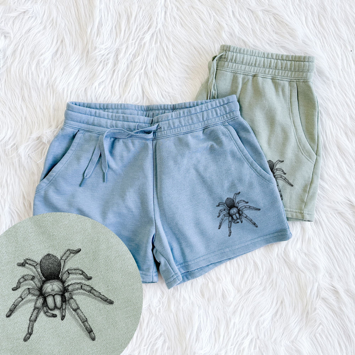 Two pairs of Cali Wave shorts in different colors printed with a detailed black ink illustration of a desert blonde tarantula, with a close-up of the print.