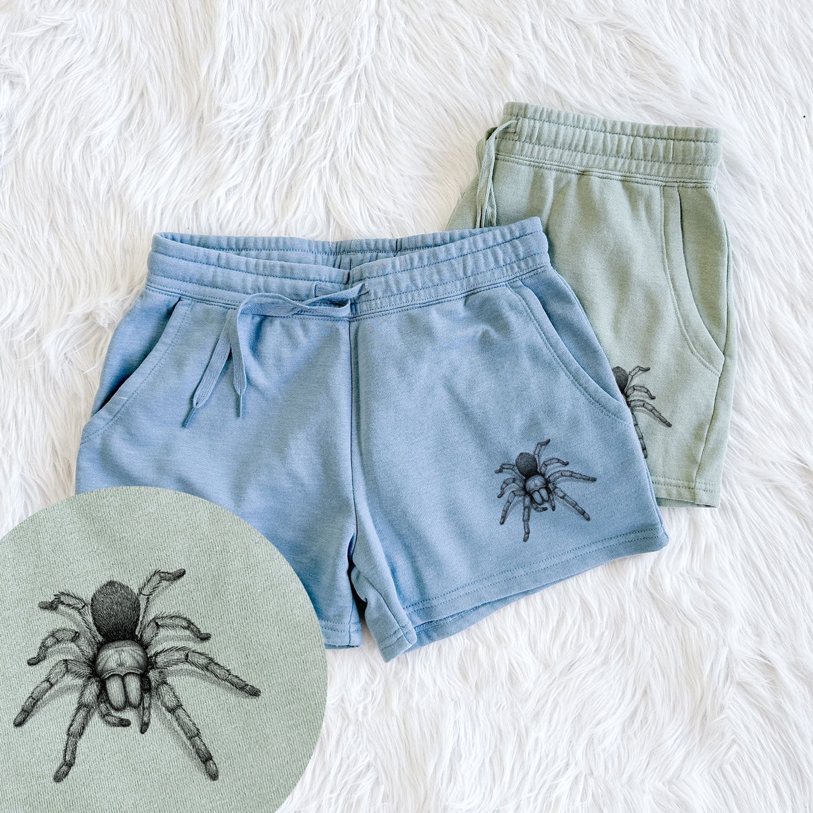 Two pairs of Cali Wave shorts in different colors printed with a detailed black ink illustration of a desert blonde tarantula, with a close-up of the print.