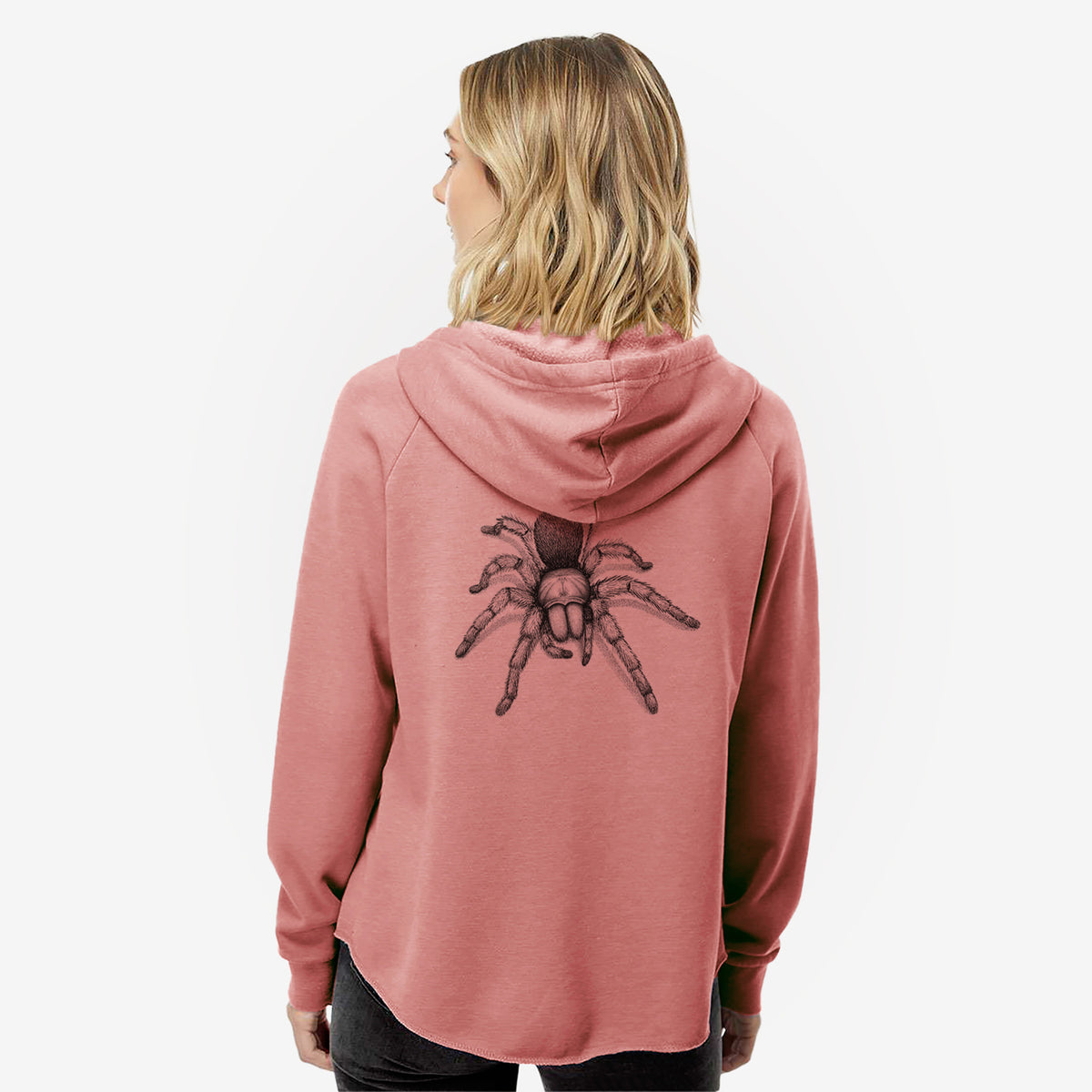 Woman wearing a dusty rose women's Cali Wave zip-up sweatshirt printed with a detailed black ink illustration of a desert blonde tarantula, seen from behind.
