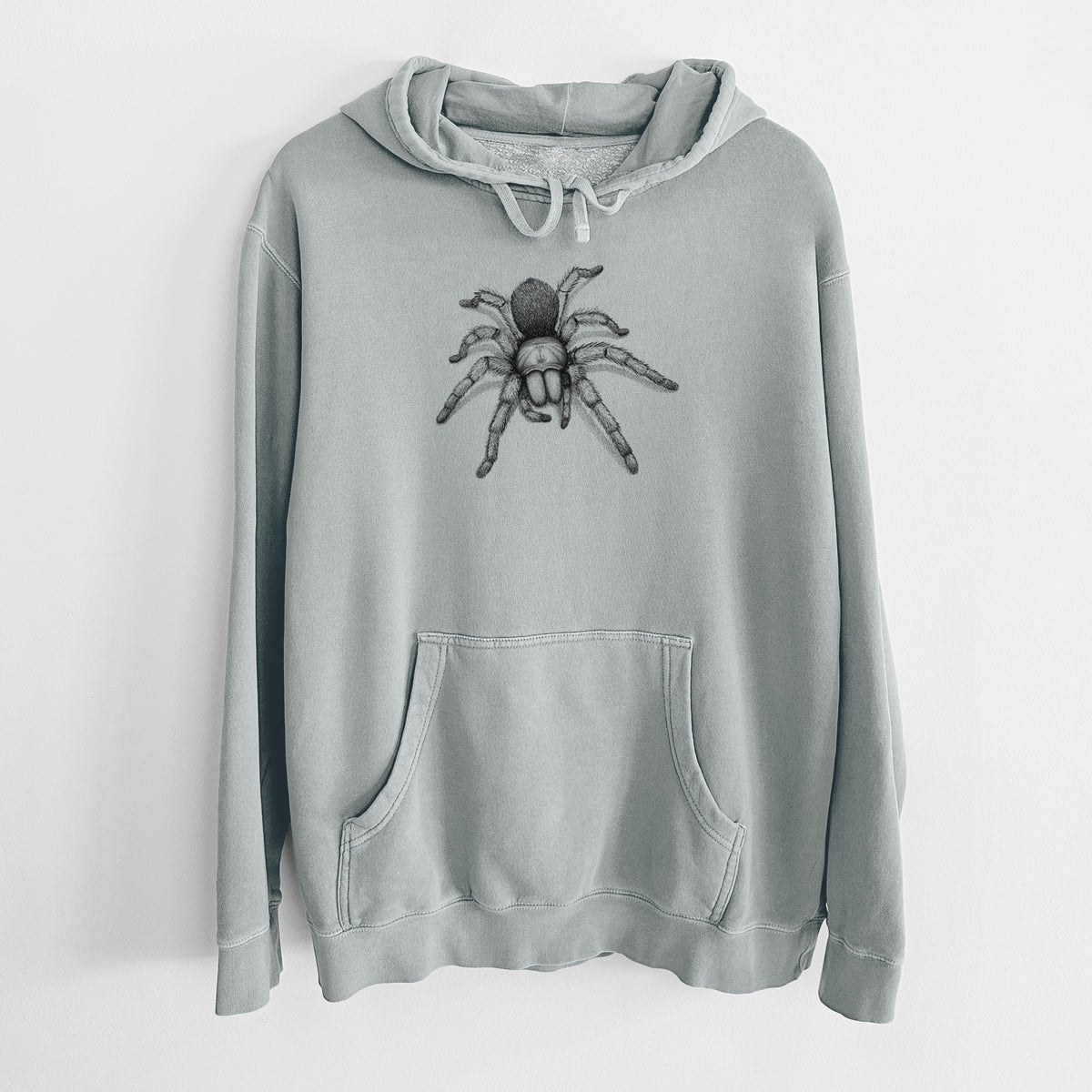 Sage green pigment dyed hoodie laid flat, printed with a detailed black ink illustration of a desert blonde tarantula.