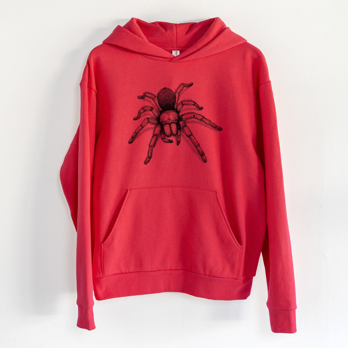 Desert Blonde Tarantula - Aphonopelma chalcodes - Statement Midweight Hoodie in Cherry Red, hanging on a white wall, with a front kangaroo pocket and no drawcords.