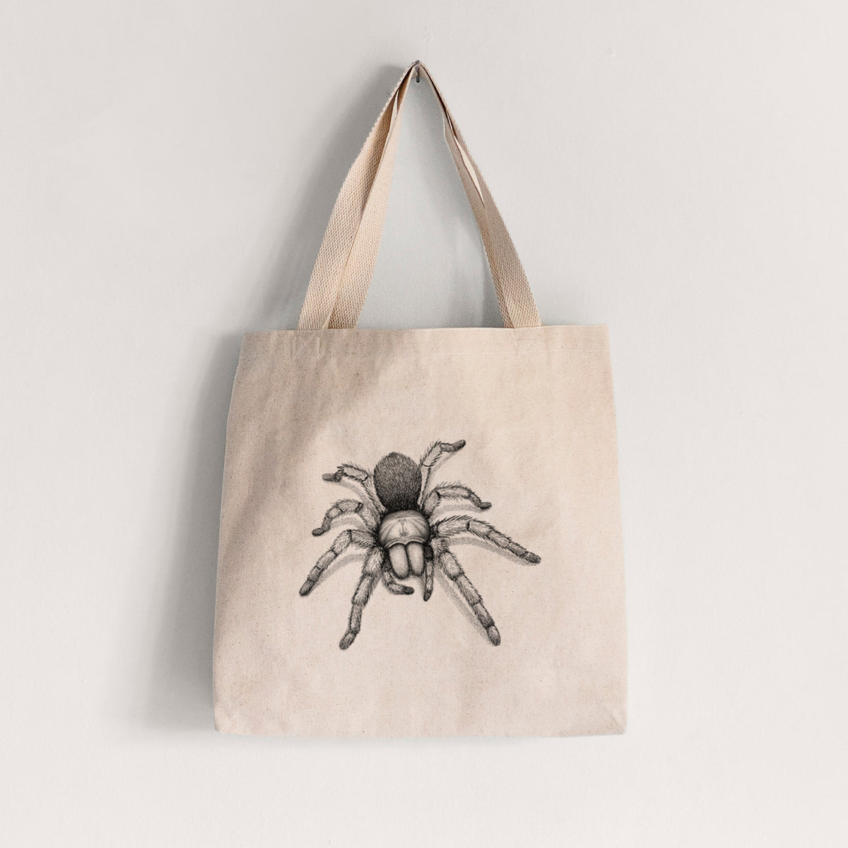 Natural canvas tote bag printed with a detailed black ink illustration of a desert blonde tarantula.