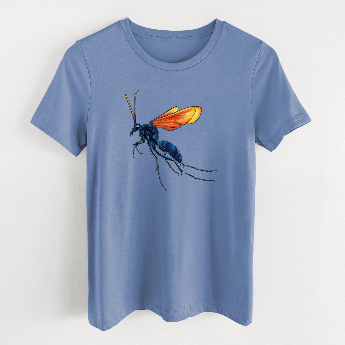 Blue bell women's relaxed fit cotton t-shirt laid flat, printed with a full-color illustration of a tarantula hawk wasp with a blue body and orange wings.