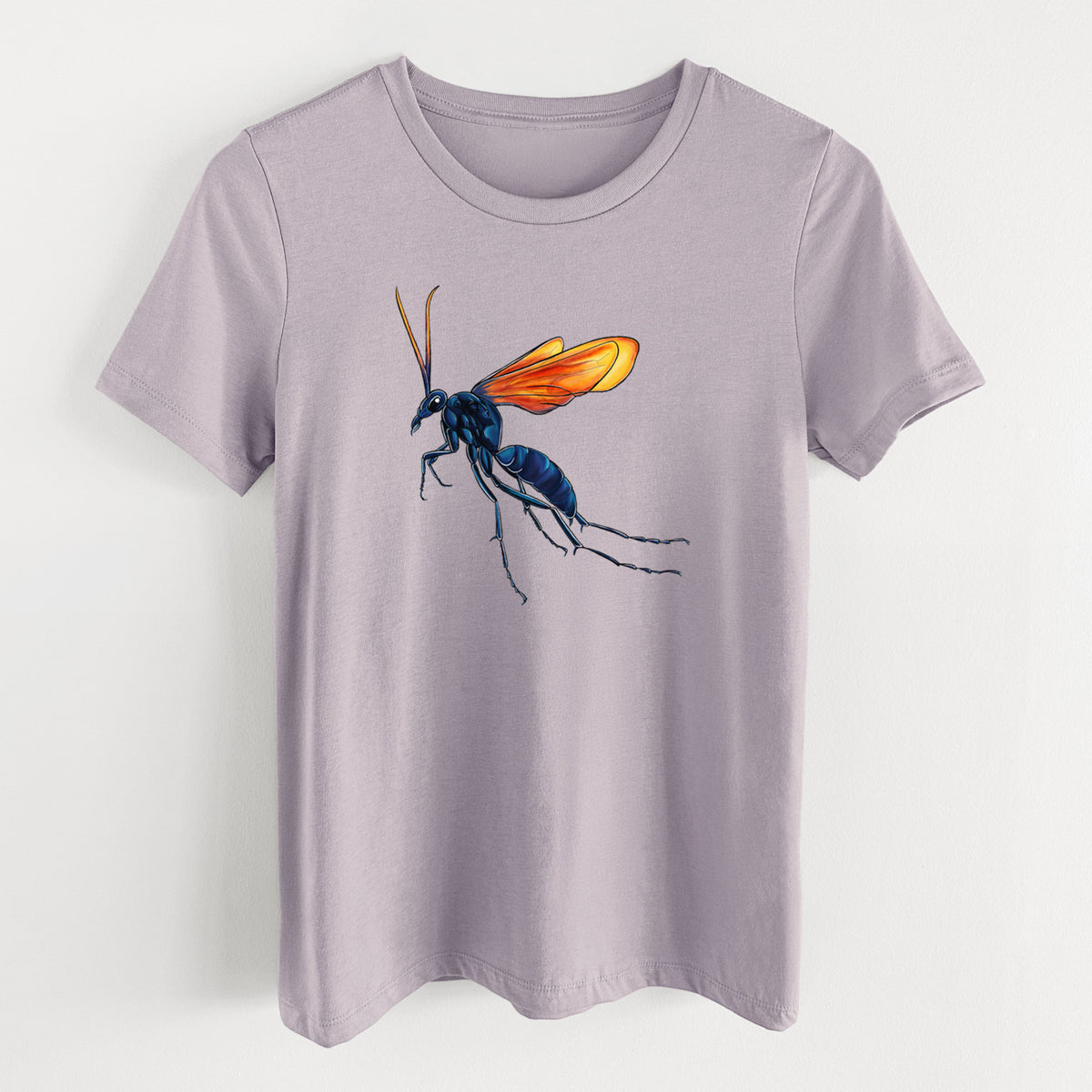 Light violet women's relaxed fit cotton t-shirt laid flat, printed with a full-color illustration of a tarantula hawk wasp with a blue body and orange wings.