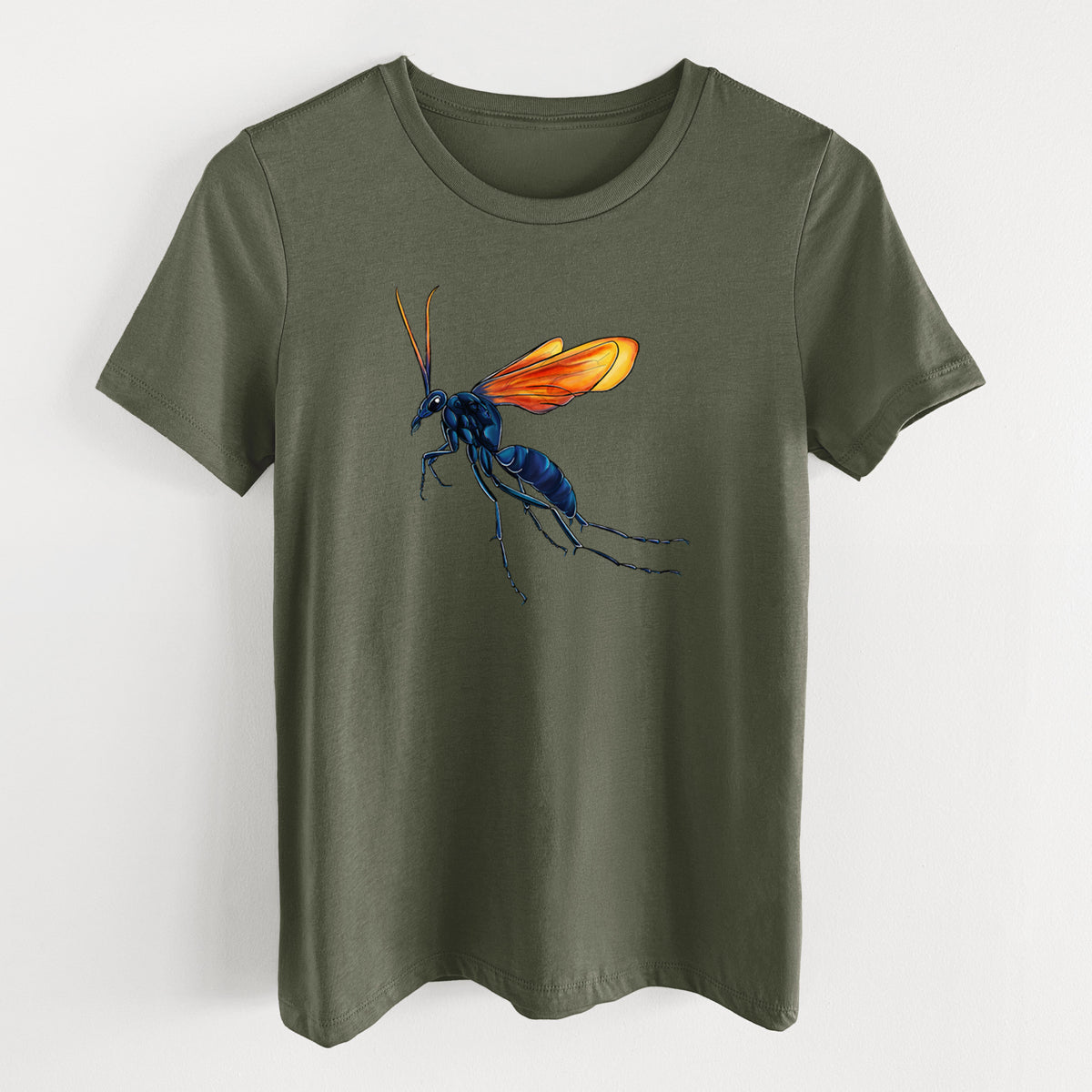 Military green women's relaxed fit cotton t-shirt laid flat, printed with a full-color illustration of a tarantula hawk wasp with a blue body and orange wings.