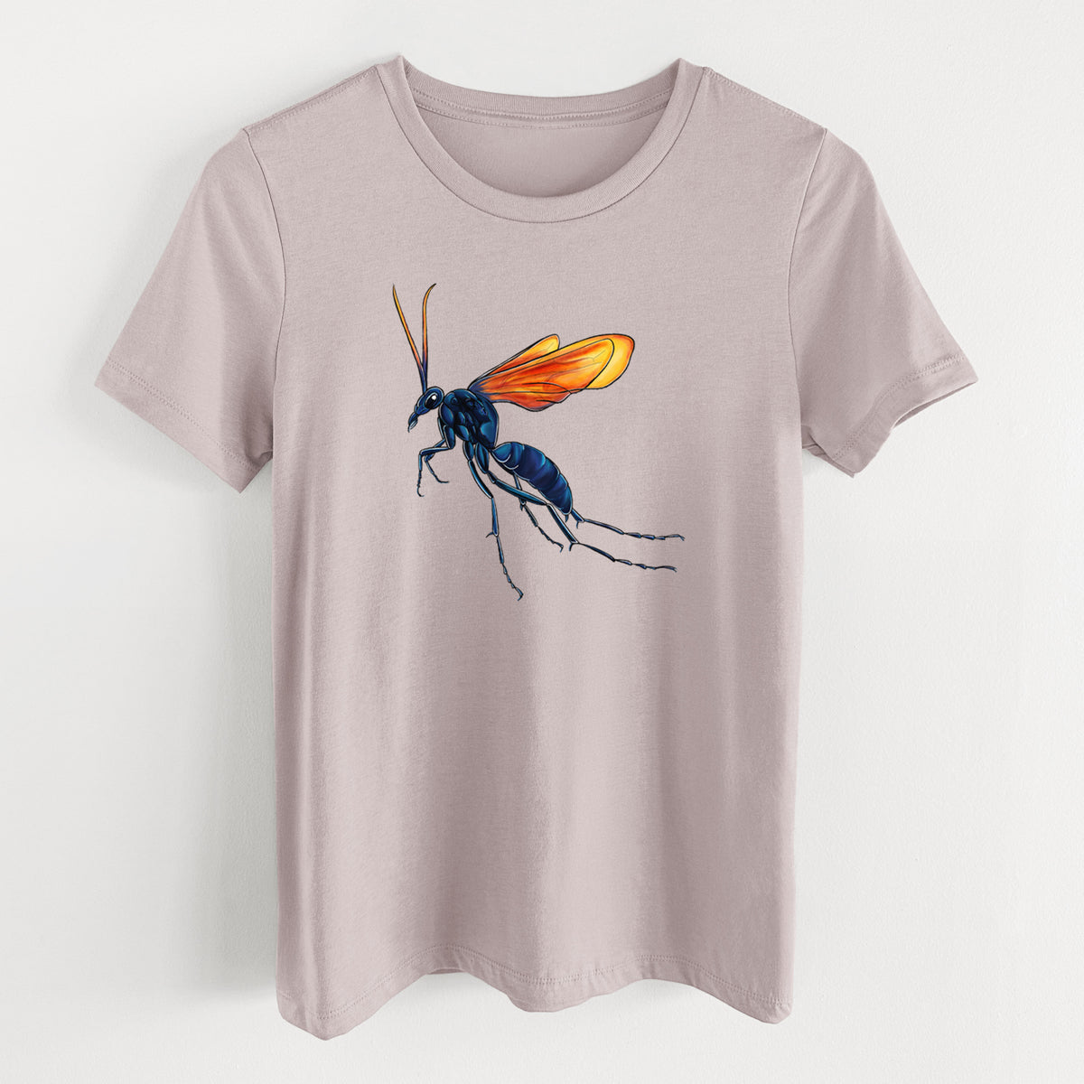 Pink gravel women's relaxed fit cotton t-shirt laid flat, printed with a full-color illustration of a tarantula hawk wasp with a blue body and orange wings.