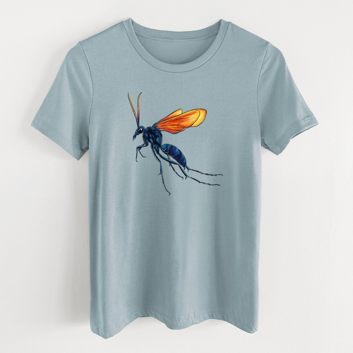 Vintage denim women's relaxed fit cotton t-shirt laid flat, printed with a full-color illustration of a tarantula hawk wasp with a blue body and orange wings.