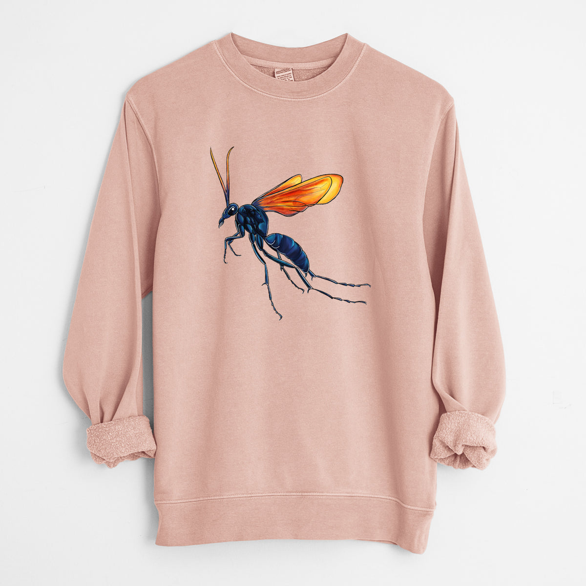 Dusty pink pigment dyed crewneck sweatshirt laid flat with the sleeves rolled, printed with a full-color illustration of a tarantula hawk wasp with a blue body and orange wings.