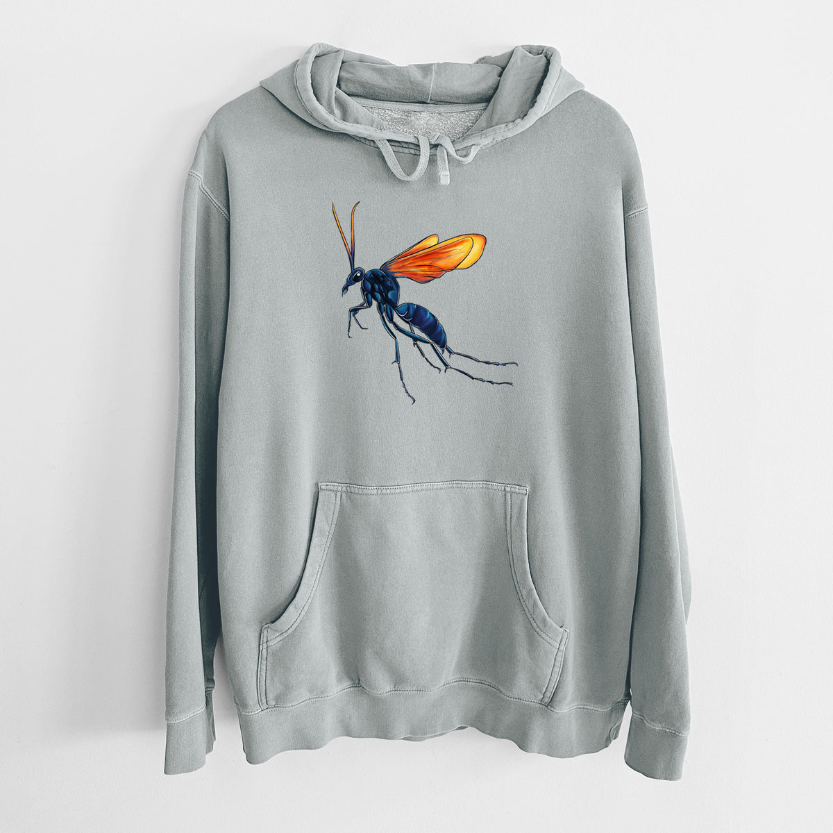 Sage green pigment dyed hoodie laid flat, printed with a full-color illustration of a tarantula hawk wasp with a blue body and orange wings.