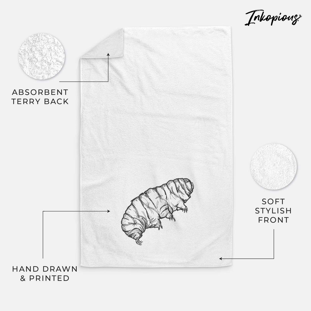 White hand towel printed with a detailed black ink illustration of a tardigrade, or water bear.