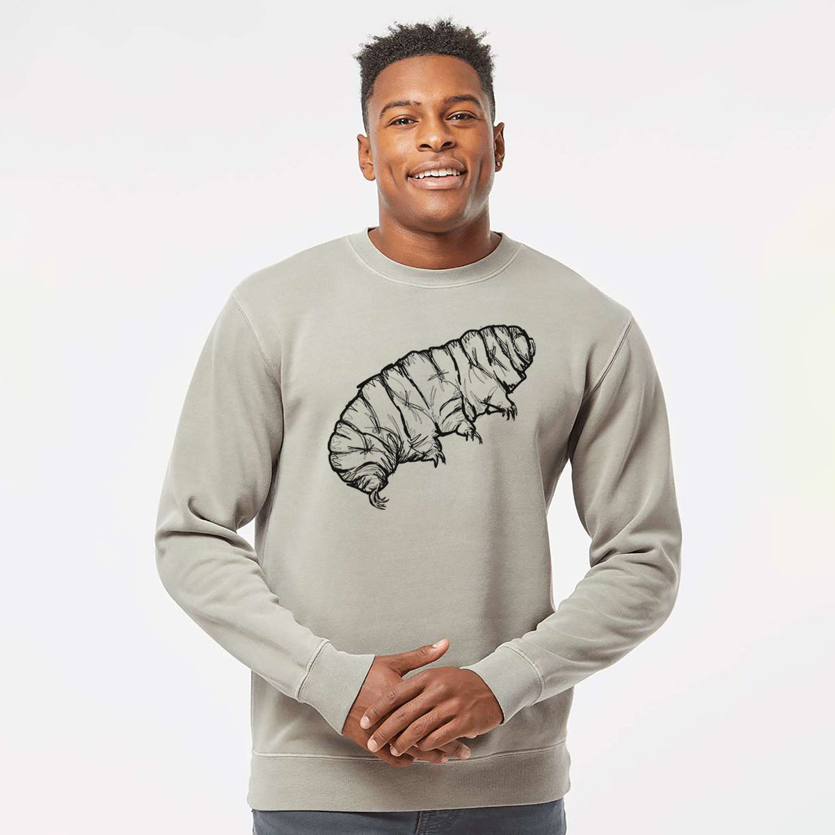 Model wearing a cement grey pigment dyed crewneck sweatshirt printed with a detailed black ink illustration of a tardigrade, or water bear.