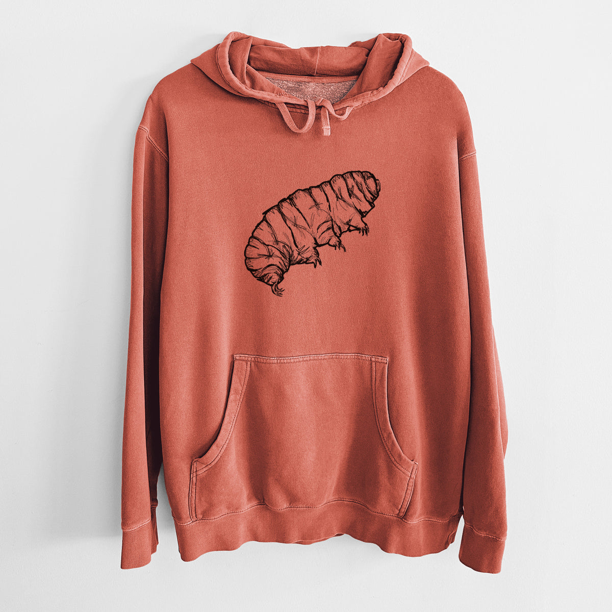 Amber orange pigment dyed hoodie laid flat, printed with a detailed black ink illustration of a tardigrade, or water bear.