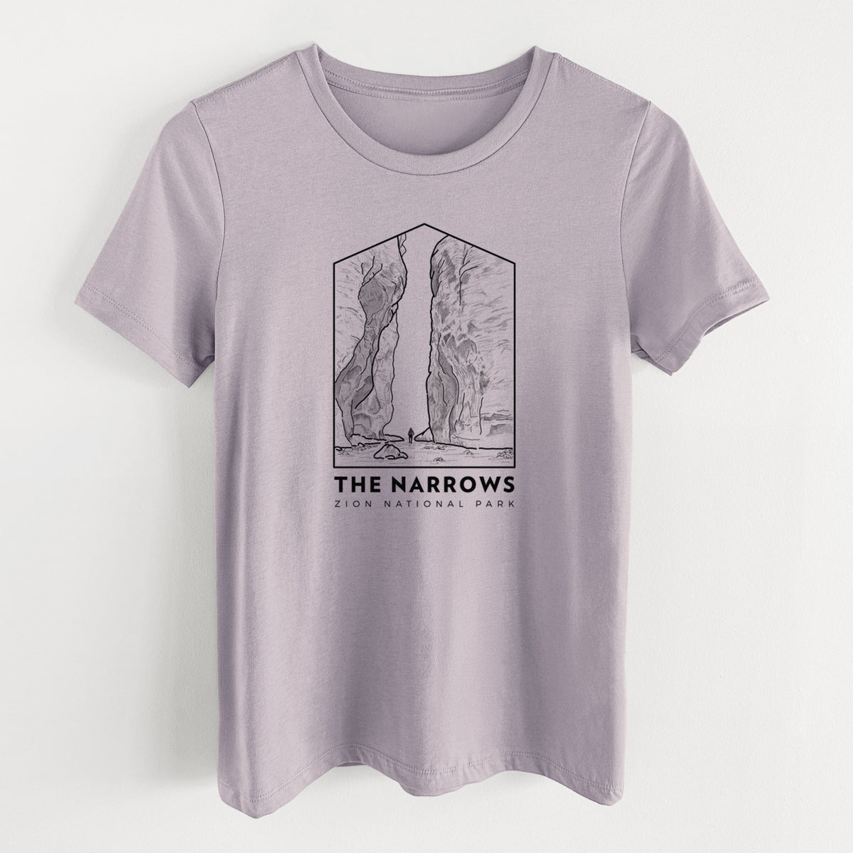 Light violet women's relaxed fit cotton t-shirt laid flat, printed with a black line art badge of the tall canyon walls of The Narrows, with the words The Narrows.