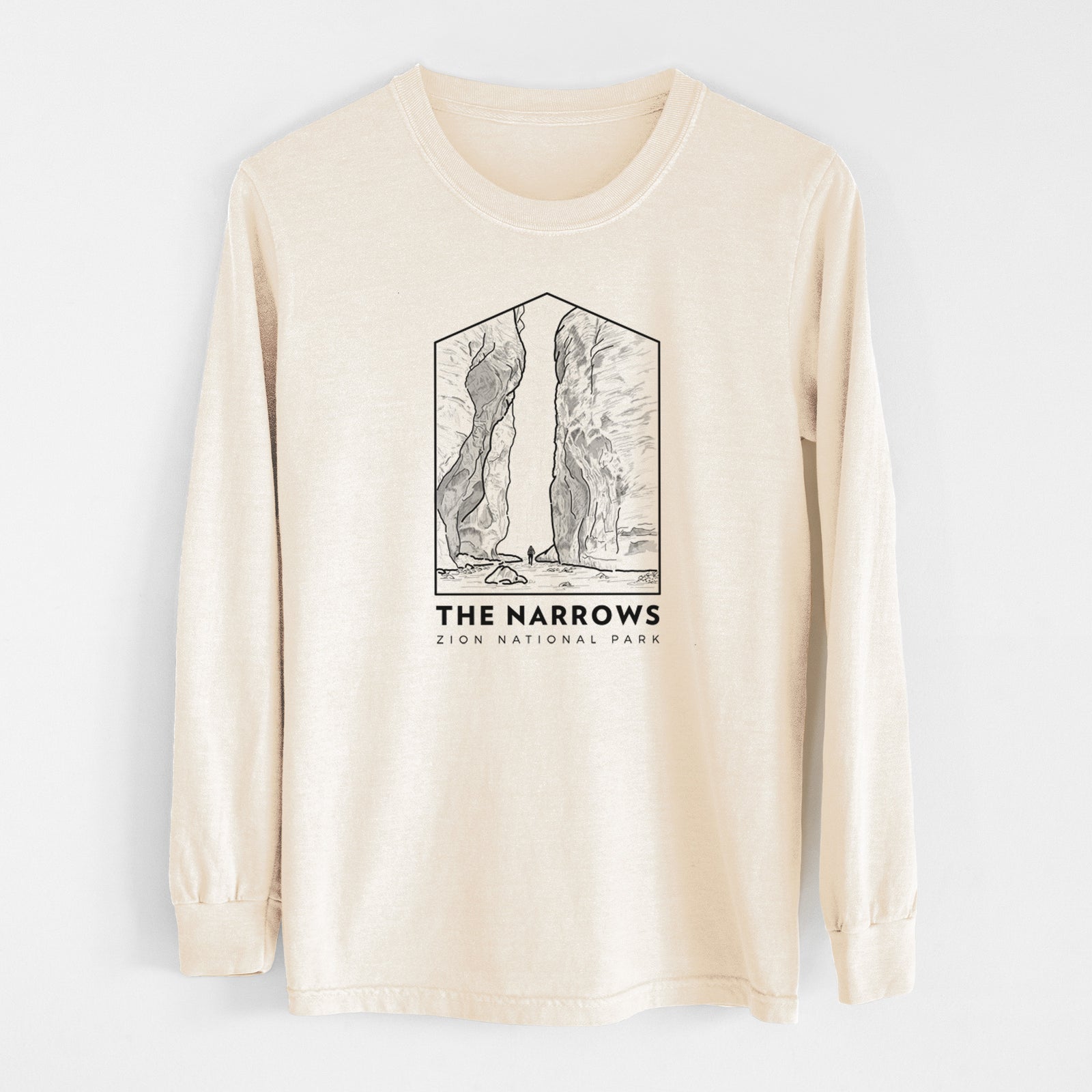 Ivory Comfort Colors long sleeve shirt laid flat, printed with a black line art badge of the tall canyon walls of The Narrows, with the words The Narrows.