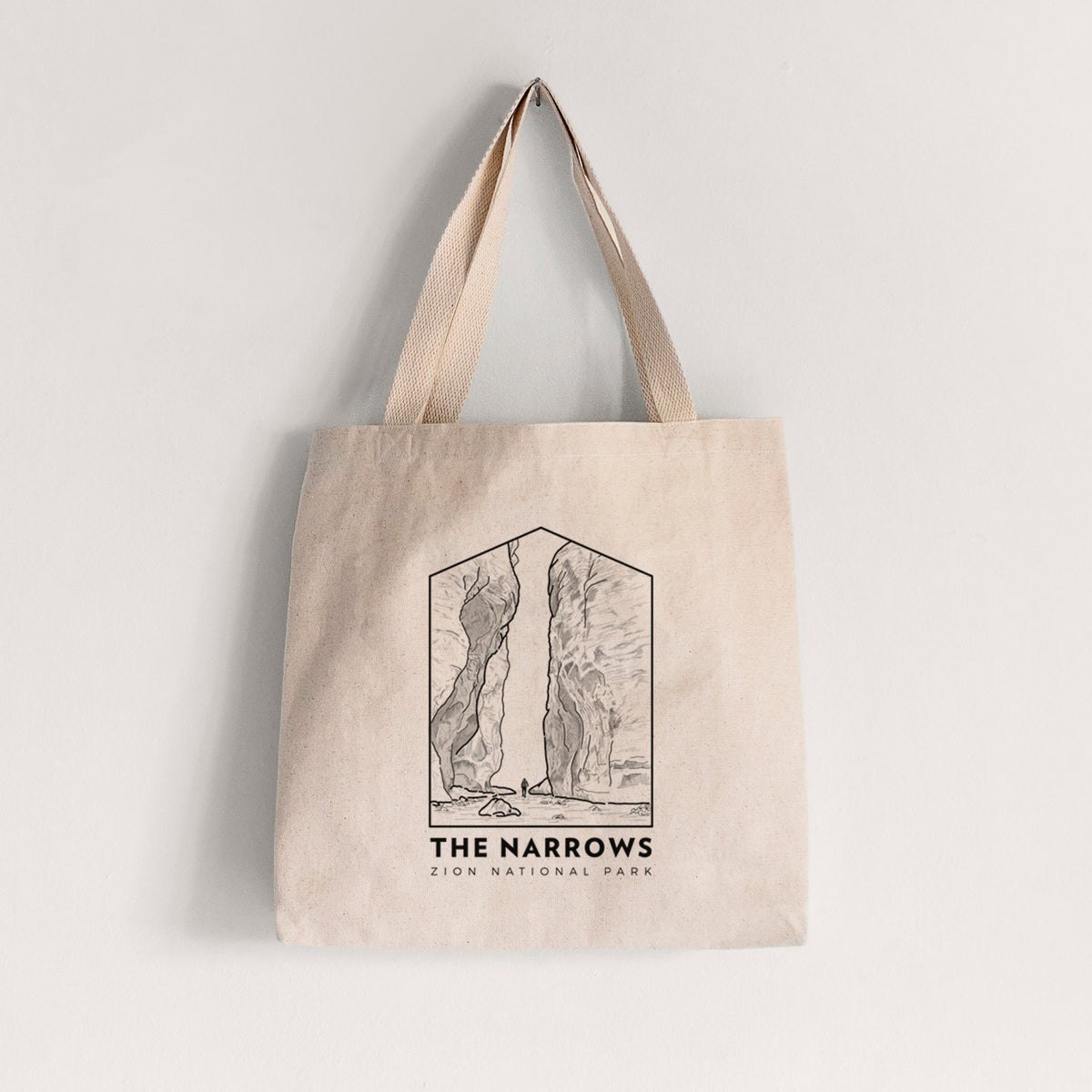 Natural canvas tote bag printed with a black line art badge of the tall canyon walls of The Narrows, with the words The Narrows.