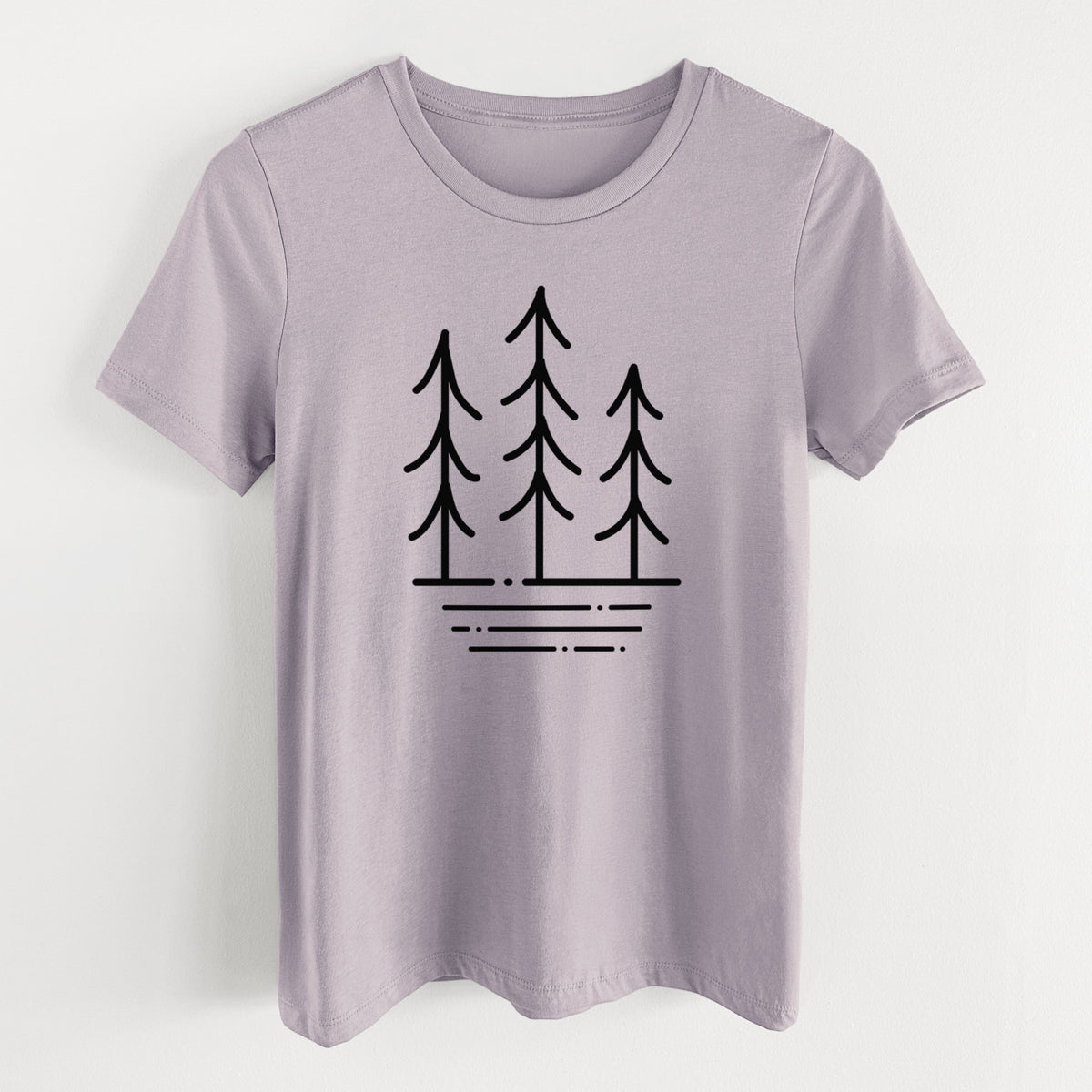 Light violet women's relaxed fit cotton t-shirt laid flat, printed with black line art of three simple pine trees above horizontal lines.