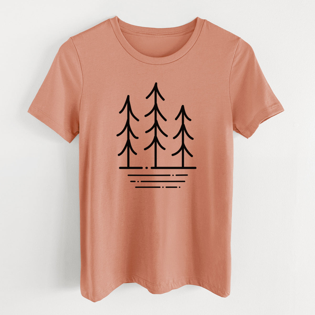 Terracotta orange women's relaxed fit cotton t-shirt laid flat, printed with black line art of three simple pine trees above horizontal lines.