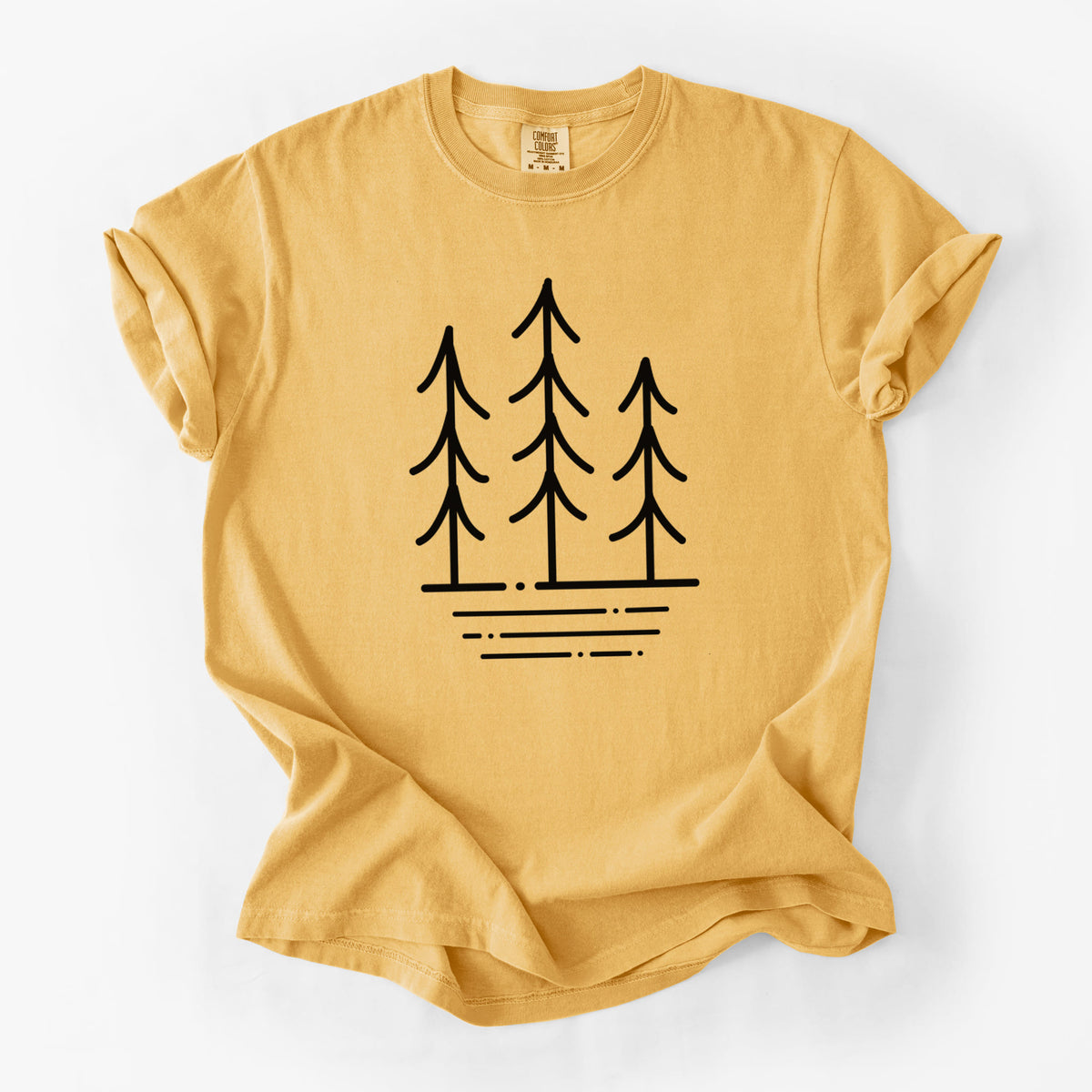 Golden wheat yellow Comfort Colors t-shirt laid flat, printed with black line art of three simple pine trees above horizontal lines.