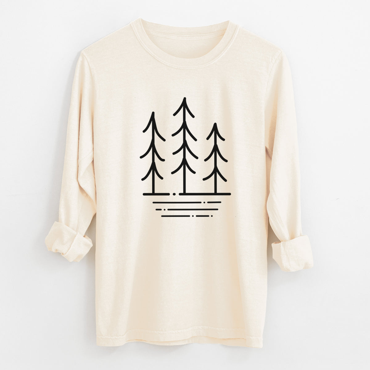 Ivory Comfort Colors long sleeve shirt laid flat with the cuffs rolled, printed with black line art of three simple pine trees above horizontal lines.