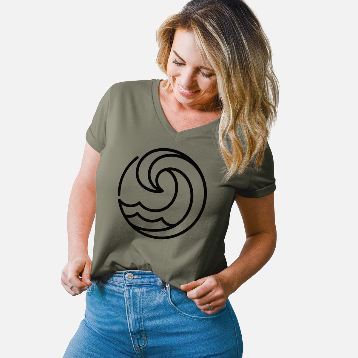 Woman wearing a military green women's relaxed fit cotton V-neck t-shirt printed with a bold black line art circle of a curling ocean wave.