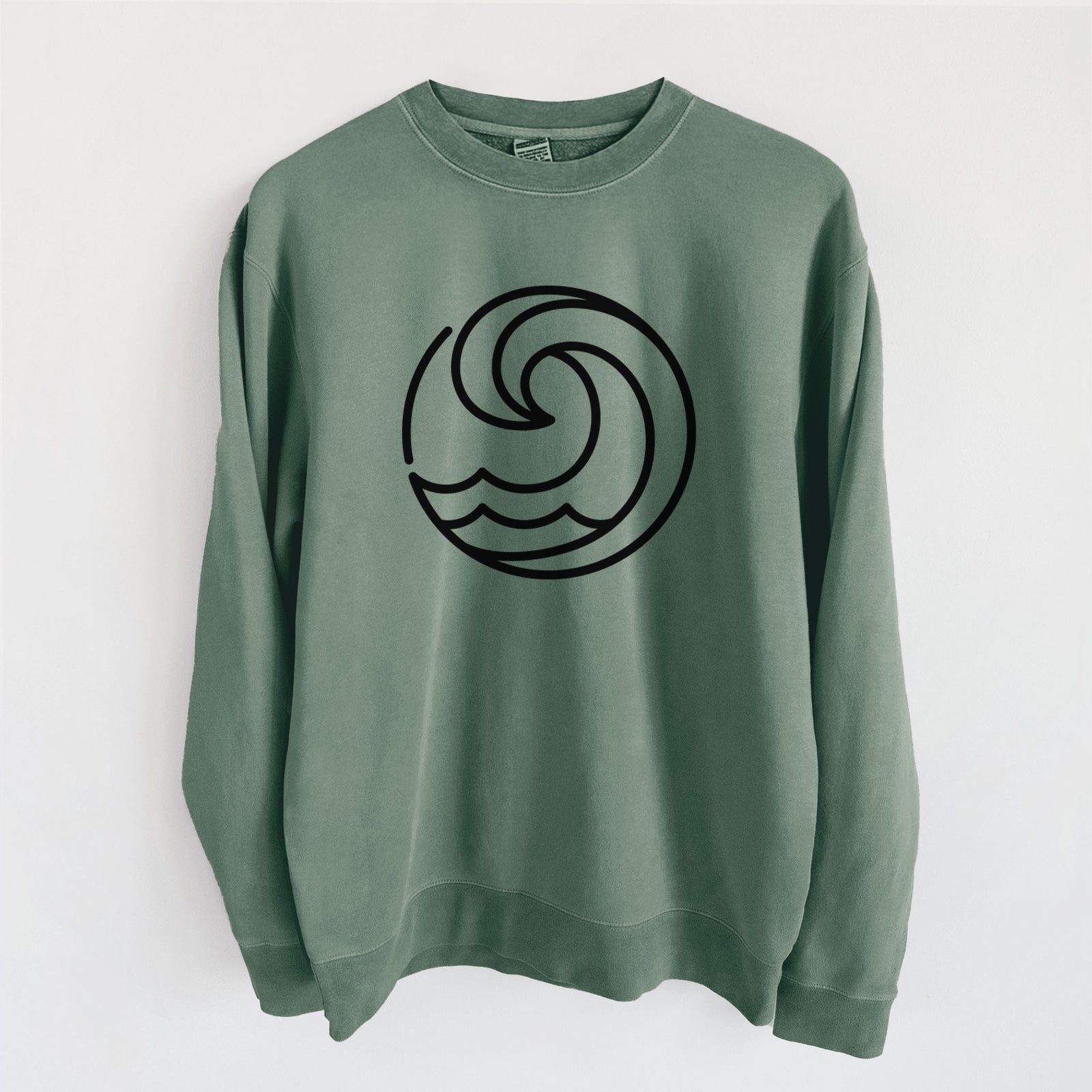 Alpine green pigment dyed crewneck sweatshirt laid flat, printed with a bold black line art circle of a curling ocean wave.