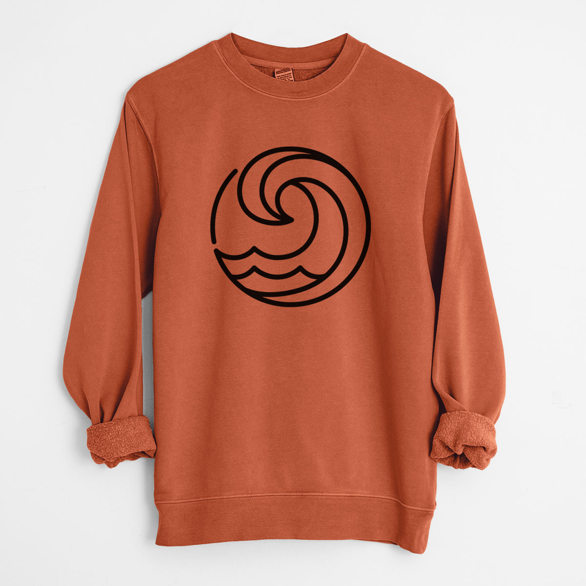 Amber orange pigment dyed crewneck sweatshirt laid flat with the sleeves rolled, printed with a bold black line art circle of a curling ocean wave.