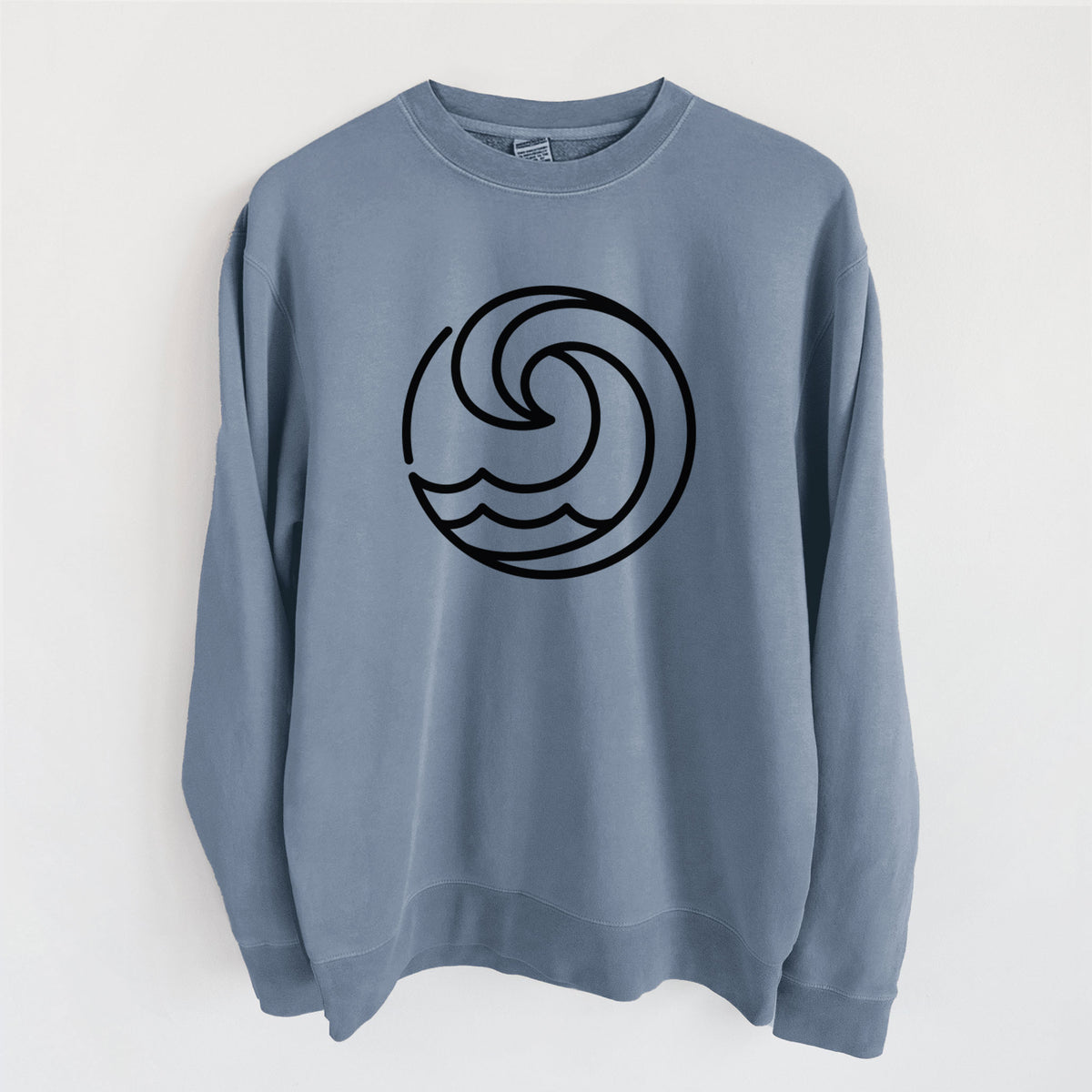 Slate blue pigment dyed crewneck sweatshirt laid flat, printed with a bold black line art circle of a curling ocean wave.