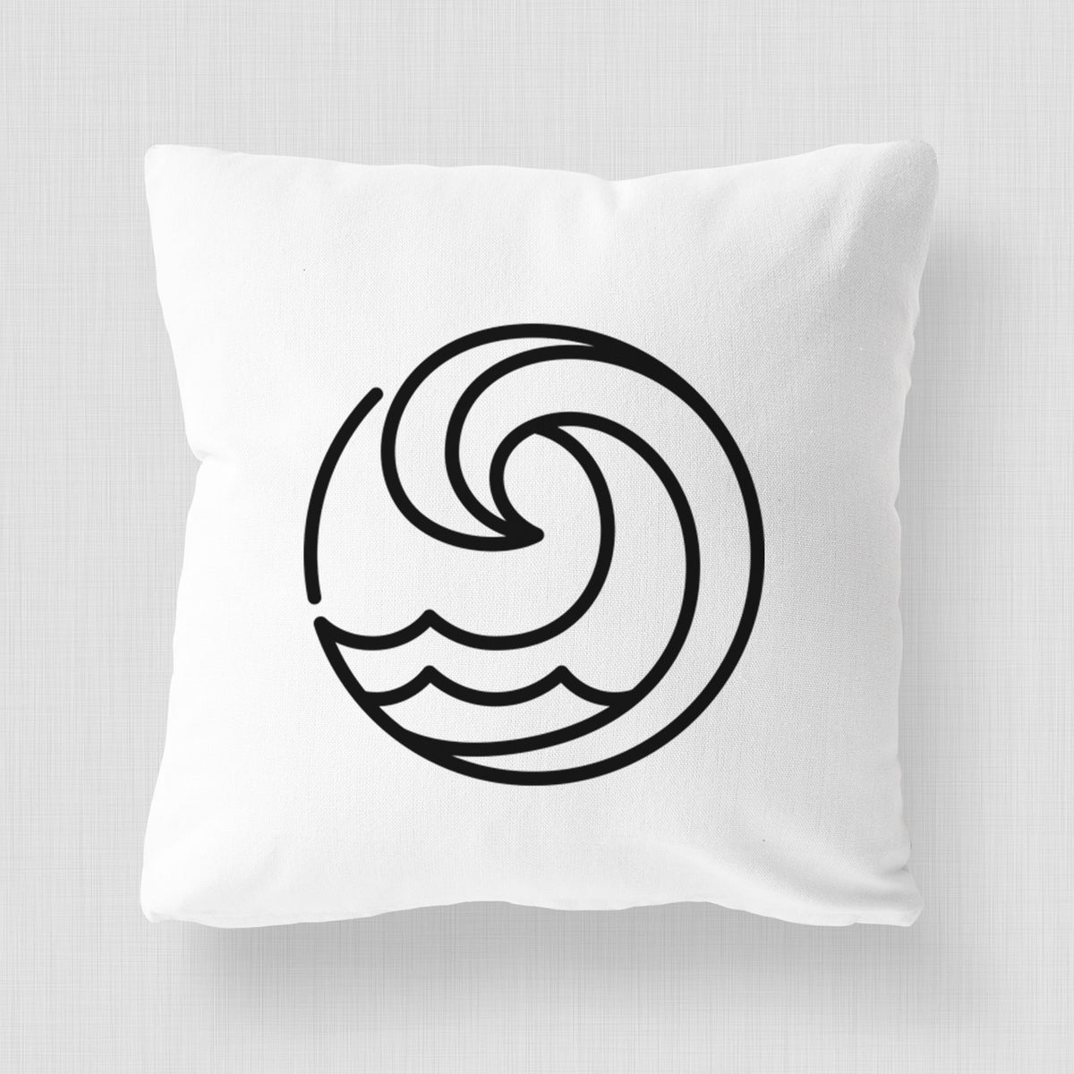 White pillow cover printed with a bold black line art circle of a curling ocean wave.