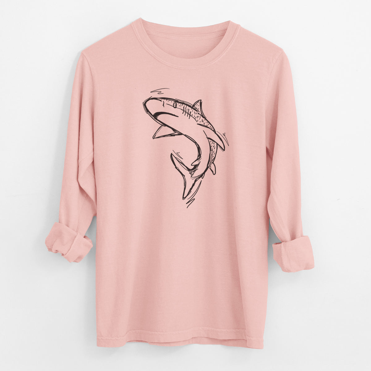 Peachy Comfort Colors long sleeve shirt laid flat with the cuffs rolled, printed with a black ink illustration of a tiger shark swimming in a curve.