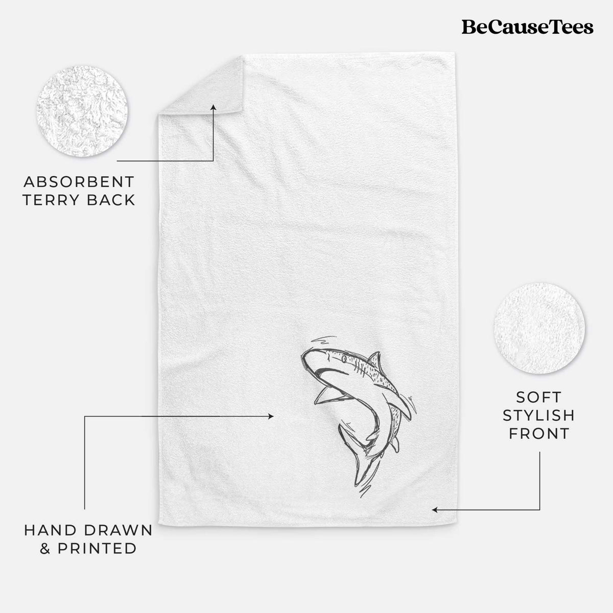 White hand towel printed with a black ink illustration of a tiger shark swimming in a curve.