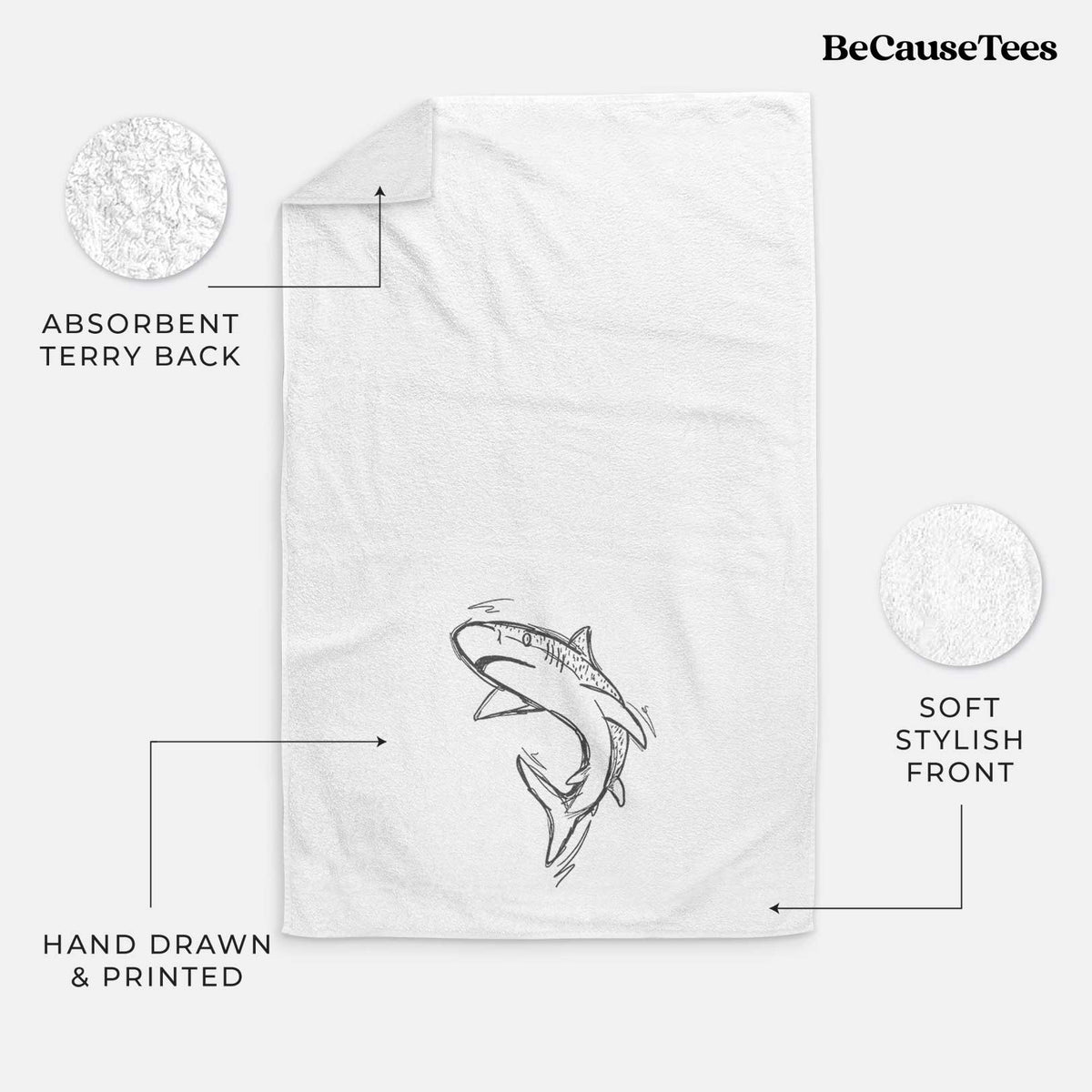 White hand towel printed with a black ink illustration of a tiger shark swimming in a curve.