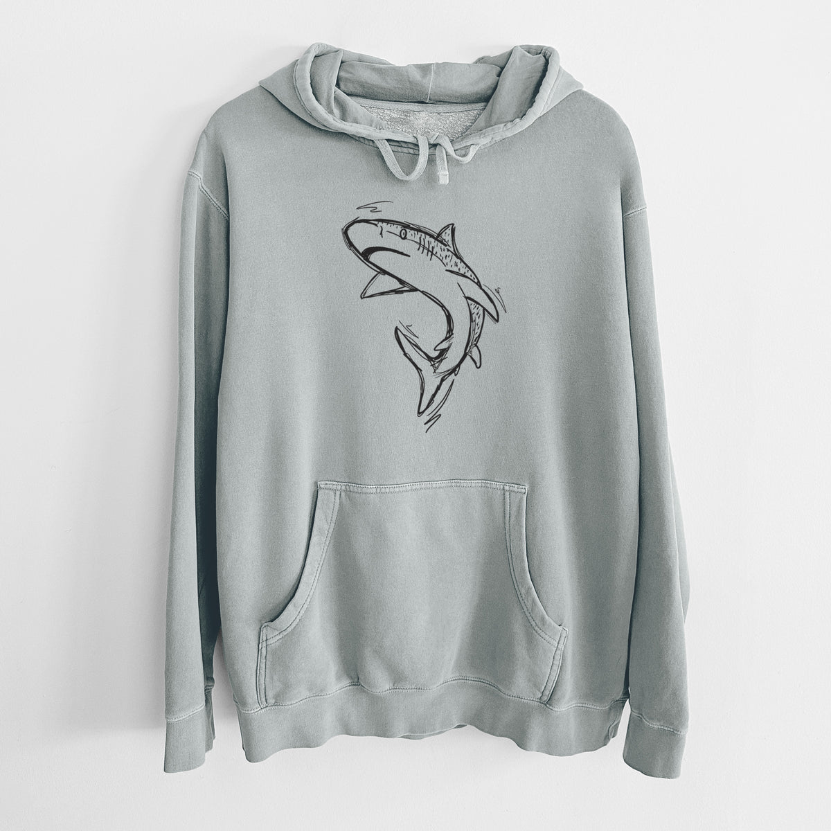 Sage green pigment dyed hoodie laid flat, printed with a black ink illustration of a tiger shark swimming in a curve.