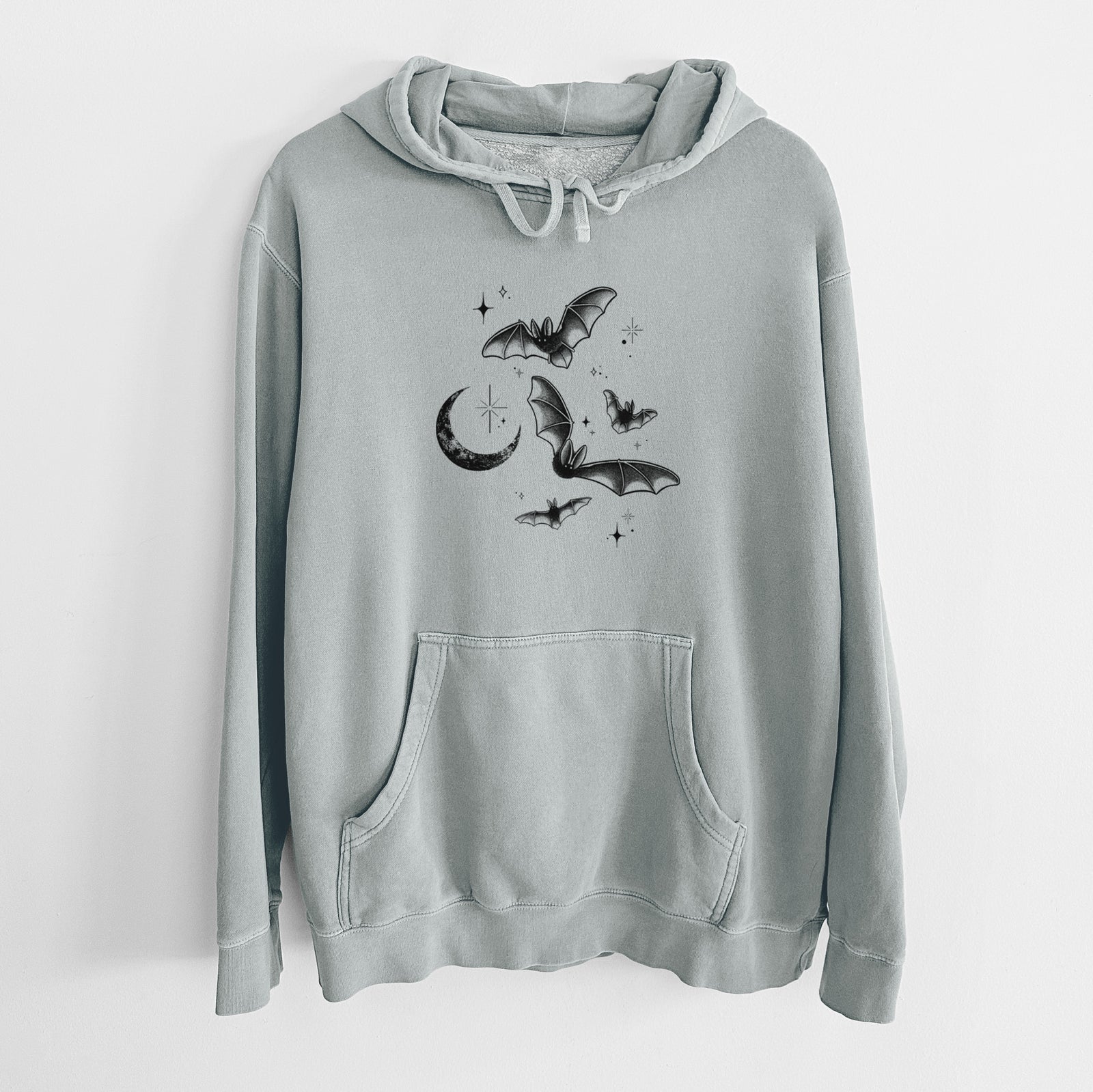 Sage green pigment dyed hoodie laid flat, printed with black ink Townsend's big-eared bats flying around a crescent moon and stars.