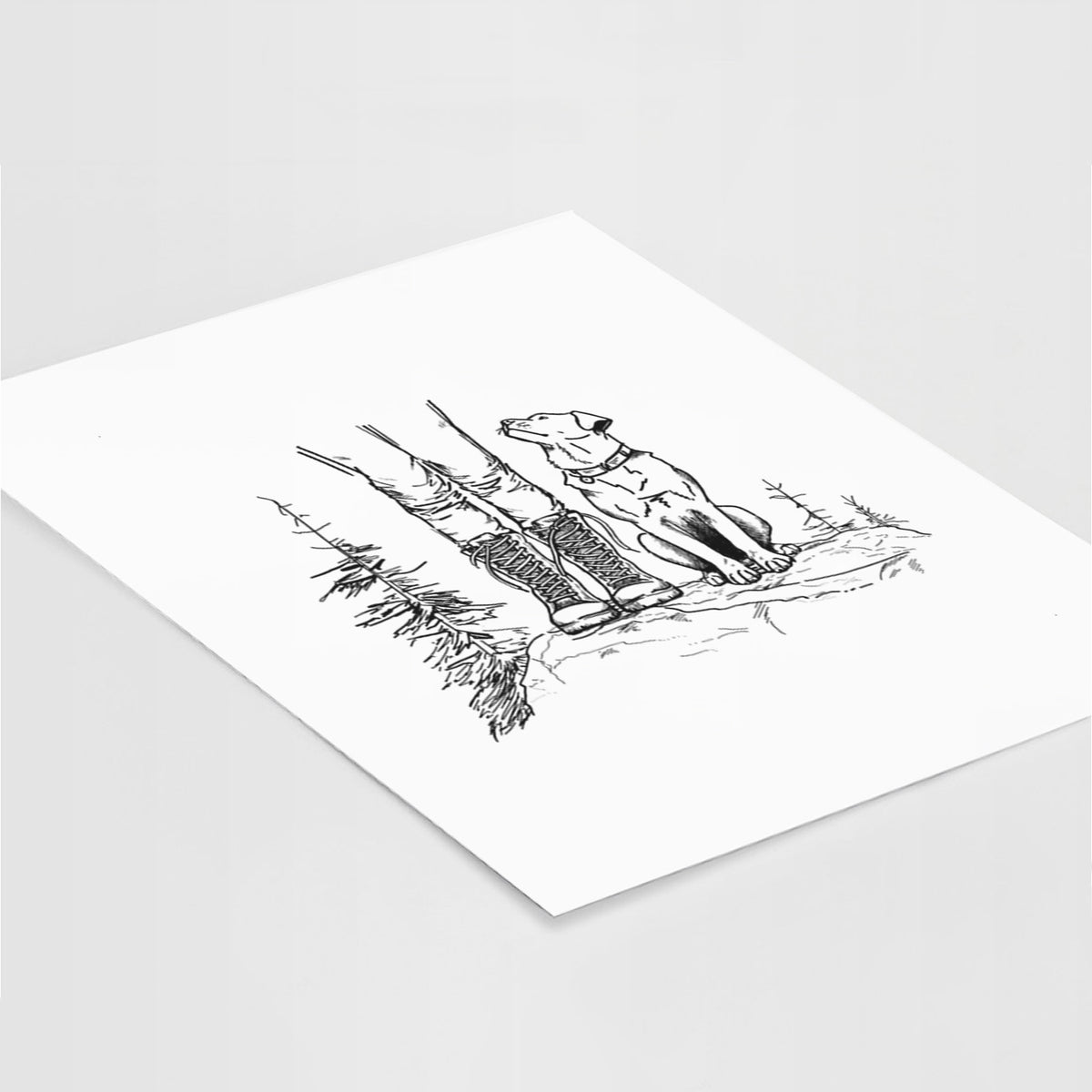 Art print of a black ink illustration of a hiker in boots and a dog sitting side by side on a forest trail, seen from behind, lying at an angle on a white surface.