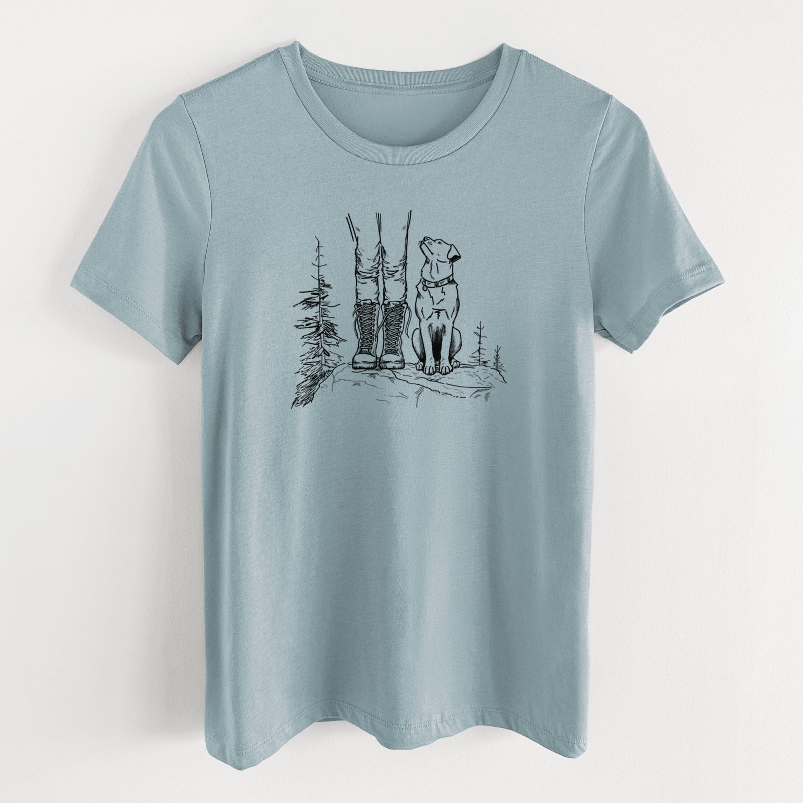 Vintage denim women's relaxed fit cotton t-shirt laid flat, printed with a black ink illustration of a hiker in boots and a dog sitting side by side on a forest trail, seen from behind.