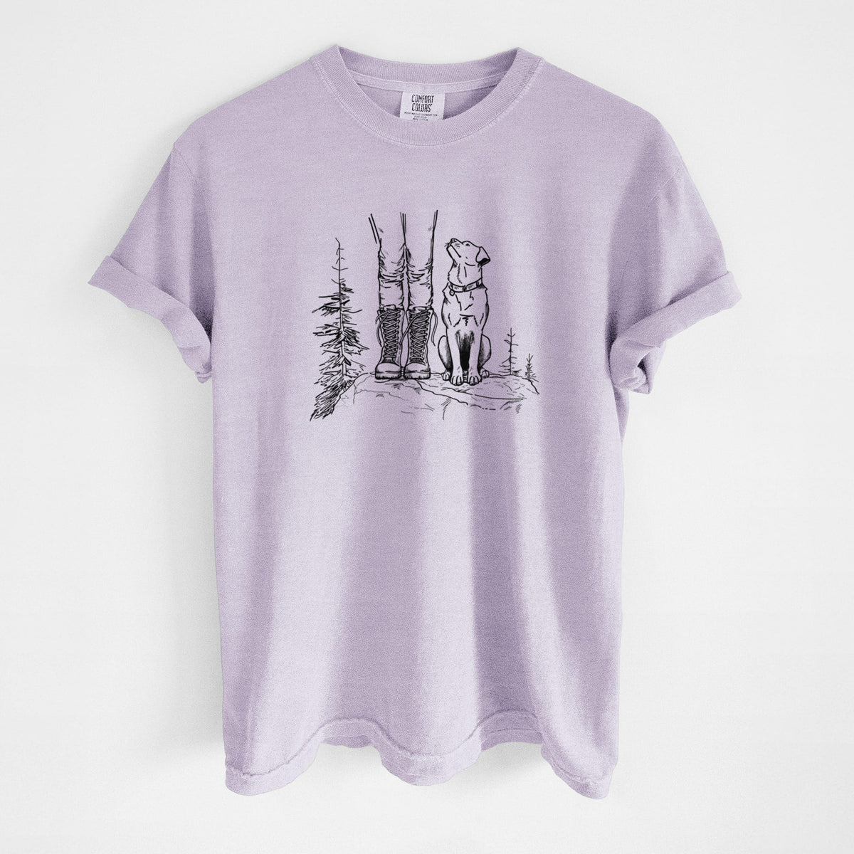 Orchid purple Comfort Colors t-shirt laid flat, printed with a black ink illustration of a hiker in boots and a dog sitting side by side on a forest trail, seen from behind.