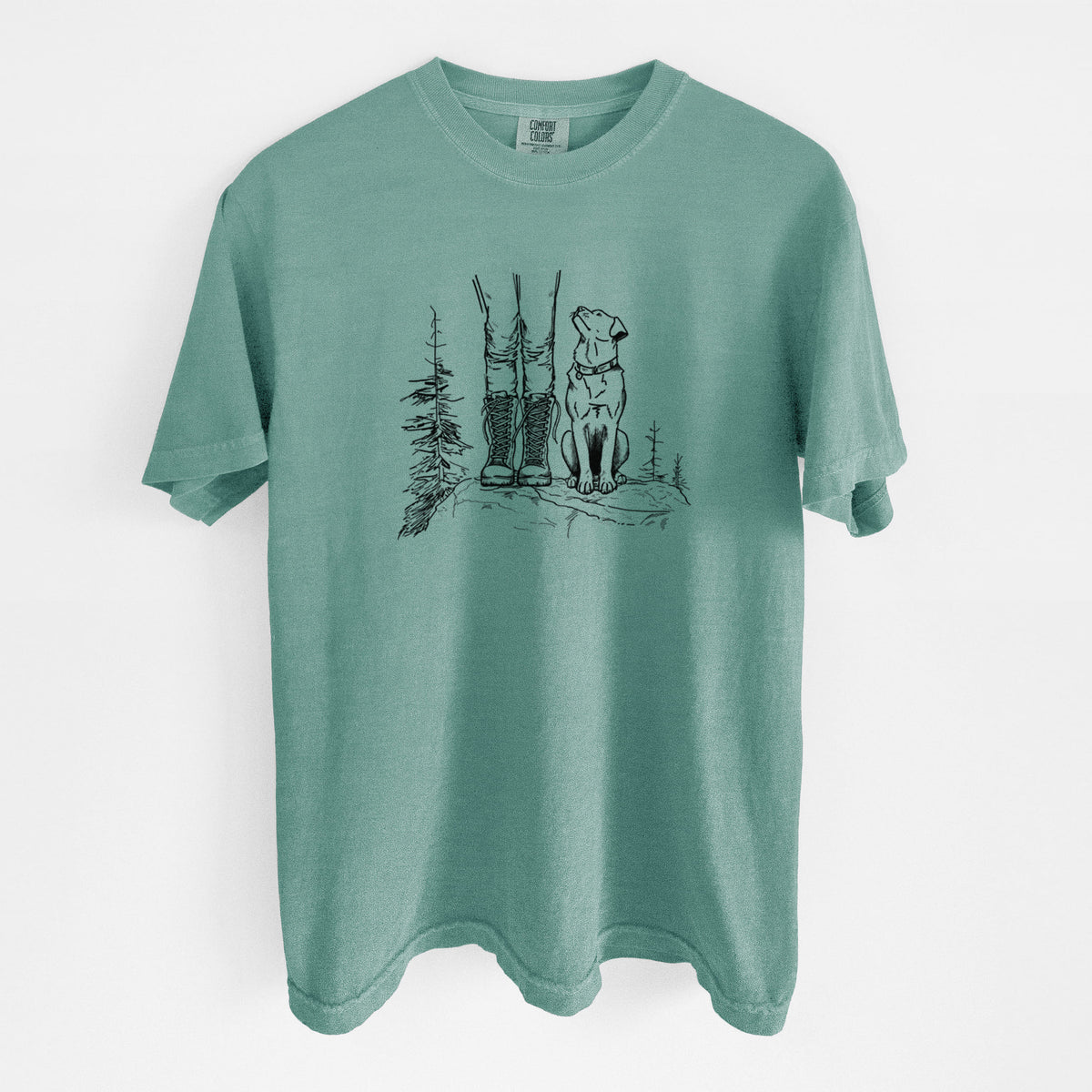 Reef green Comfort Colors t-shirt laid flat, printed with a black ink illustration of a hiker in boots and a dog sitting side by side on a forest trail, seen from behind.